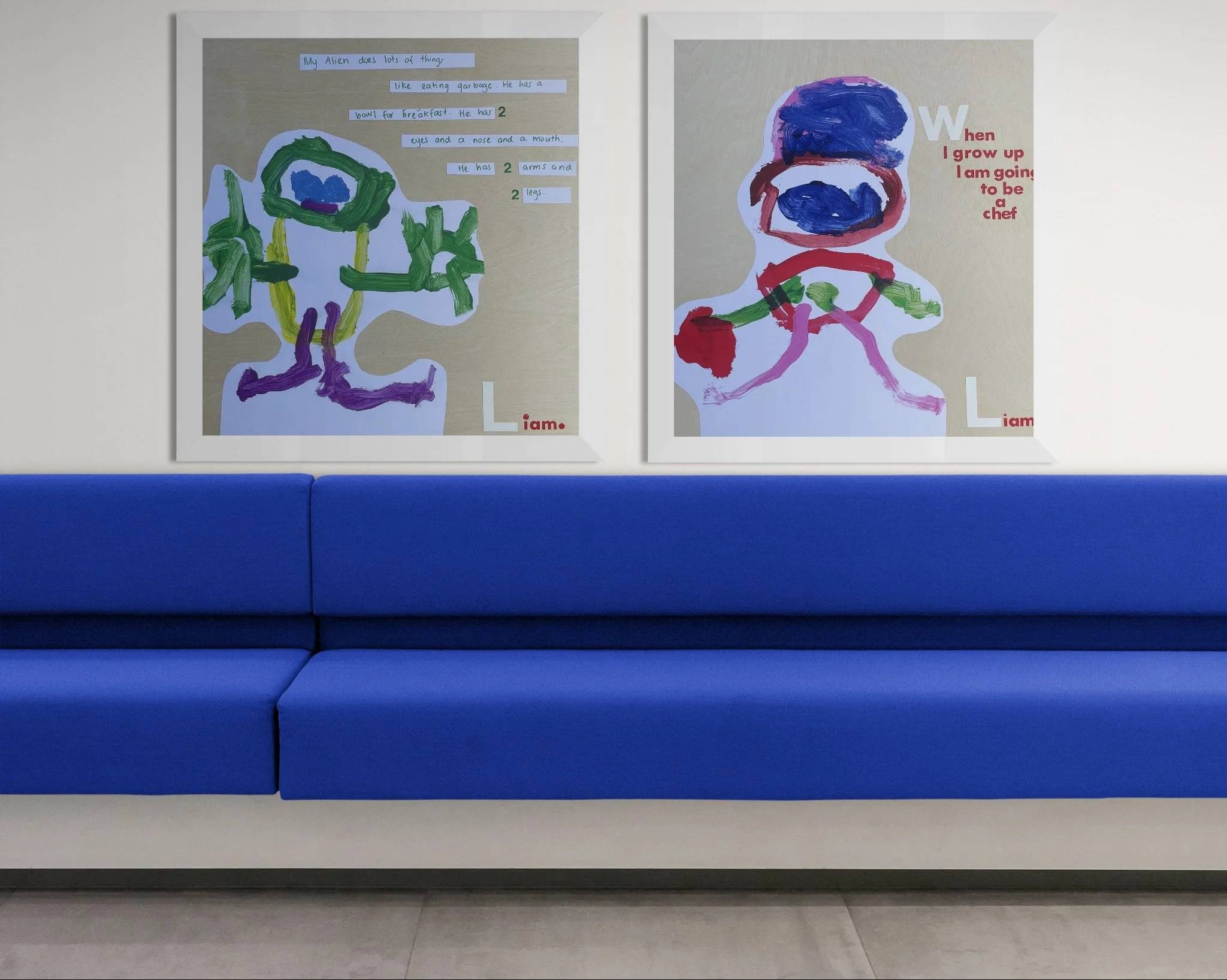 Two children's drawings of aliens on display above a blue bench. The first drawing shows a green alien with purple legs, and the second shows a colorful face with a flower. Both have text around them.