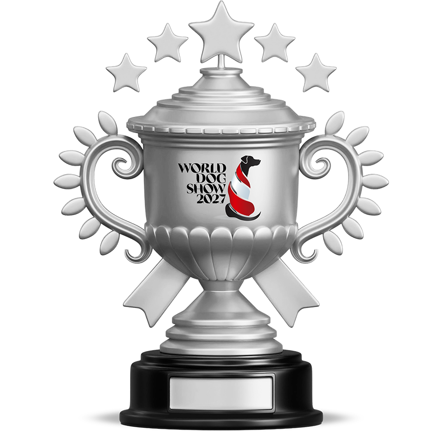 Silver trophy cup with 'World Dog Show 2027' logo featuring a black dog silhouette with a red and white striped scarf, topped with five stars and decorated with petal-like designs on handles.