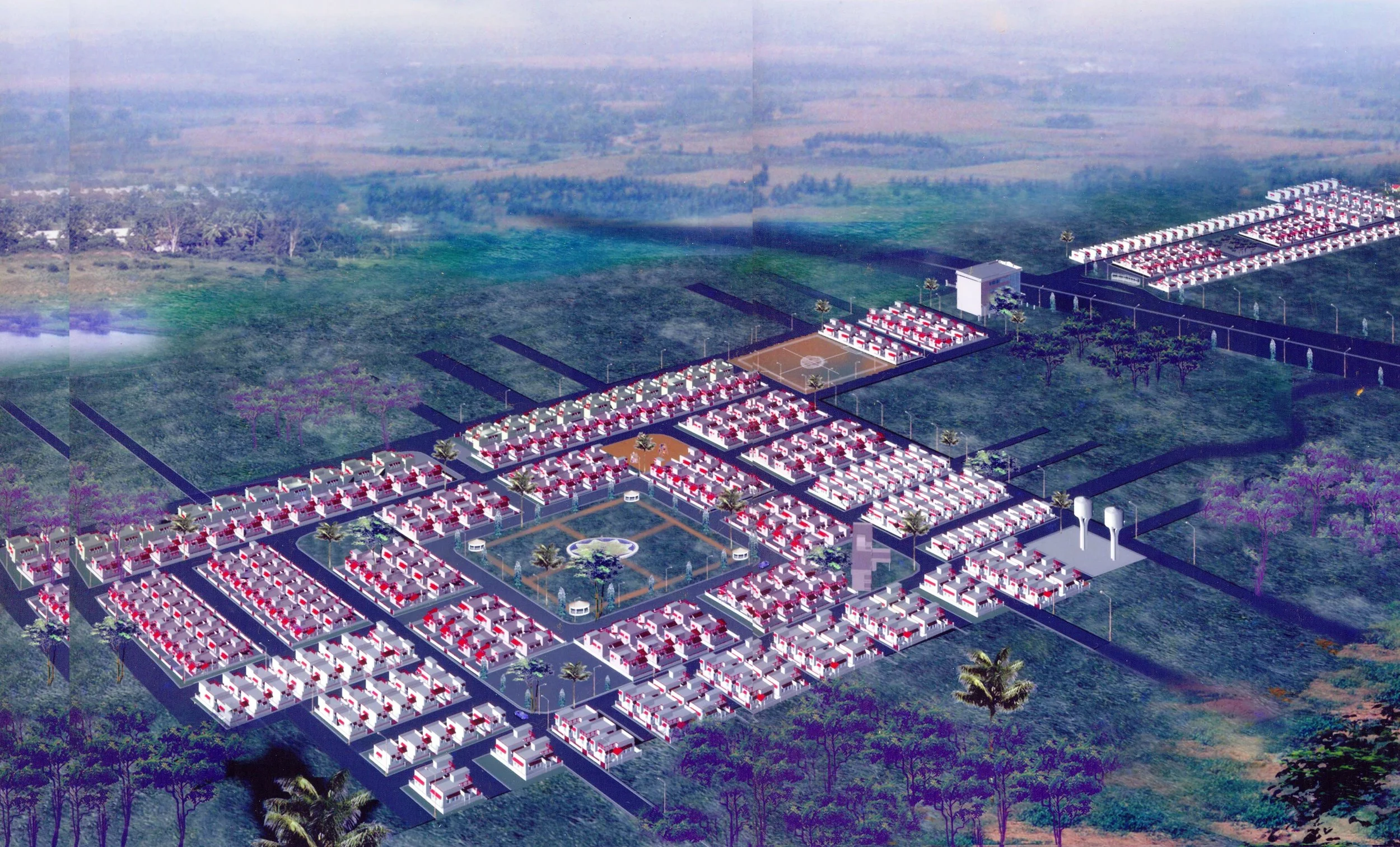 Aerial view of a planned residential community with multiple rows of white houses with red roofs, a central park with fountains, tennis courts, and surrounding green farmland.