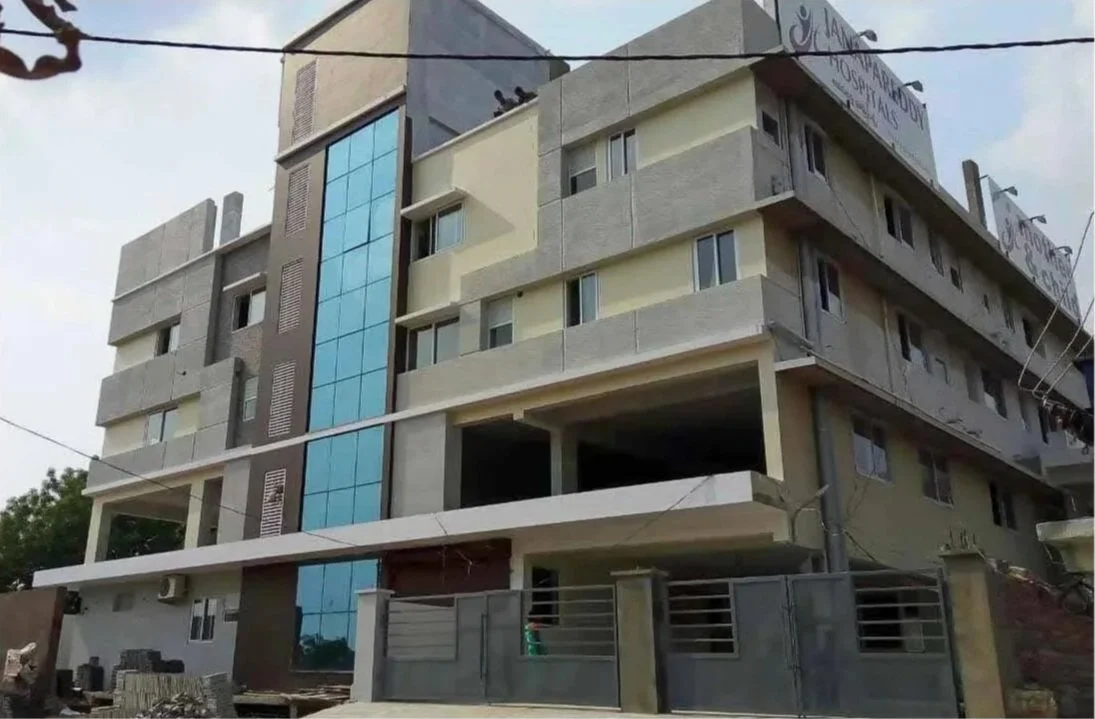 Multi-story building under construction with glass windows and a modern design.