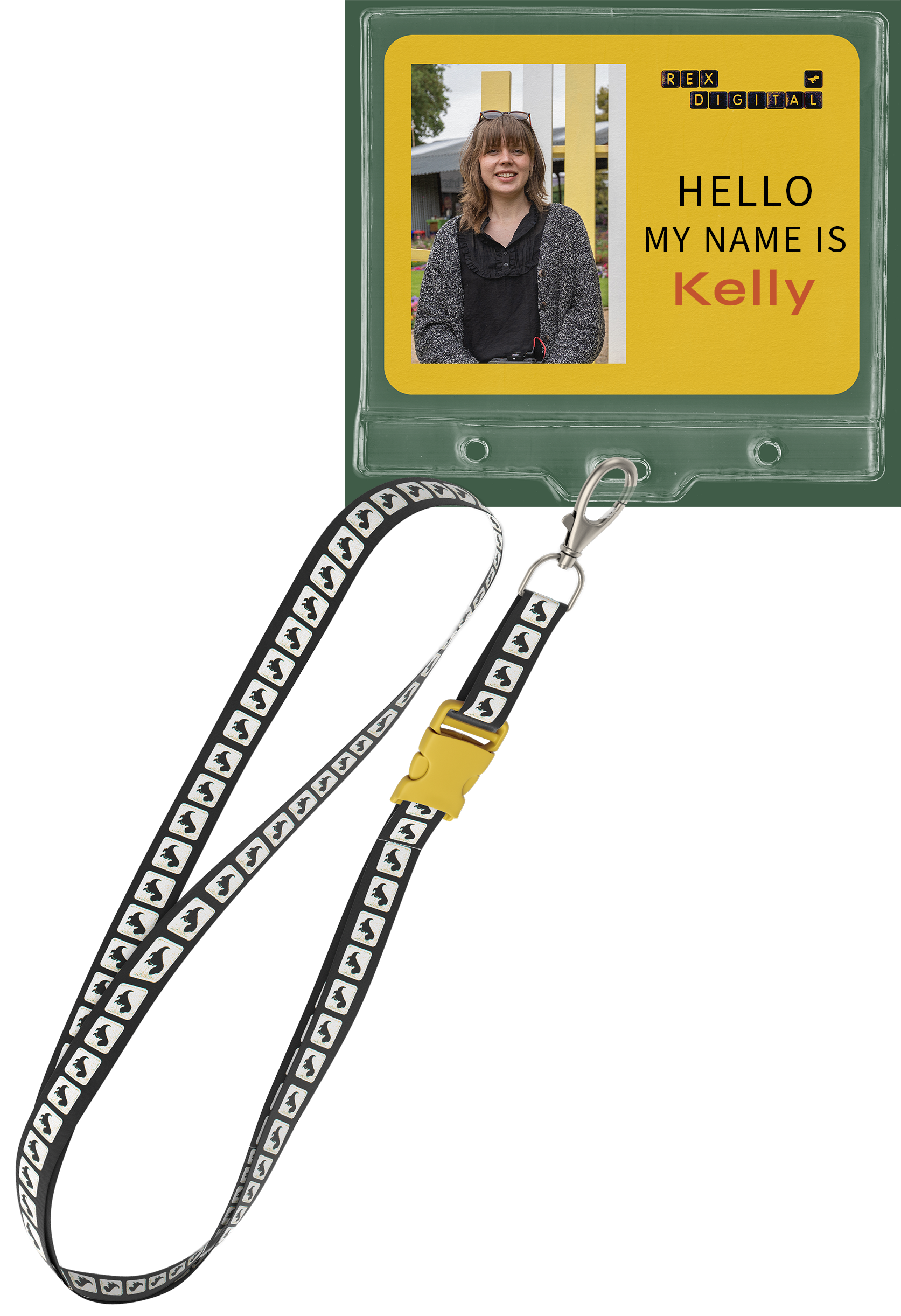 Name badge with a photo of a smiling woman with shoulder-length brown hair, wearing glasses on her head, in front of a yellow background that reads 'HELLO MY NAME IS Kelly' and some black letters spelling 'REX DIGITAL' in the top right corner, attached to a lanyard with a penguin pattern.