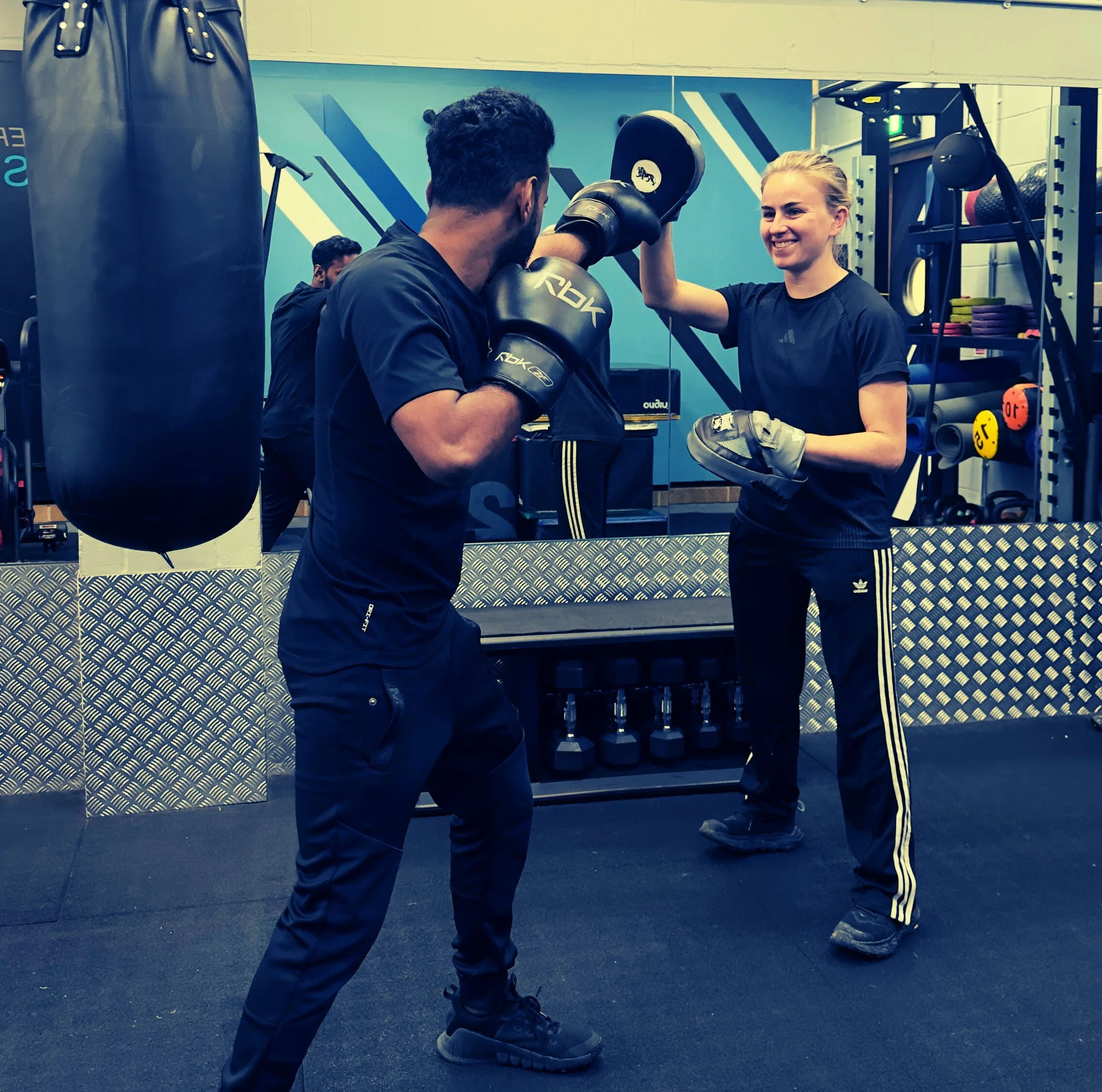 Scenic view of snow-capped mountains in the background, rolling hills in the foreground, and modern buildings on the hillside.