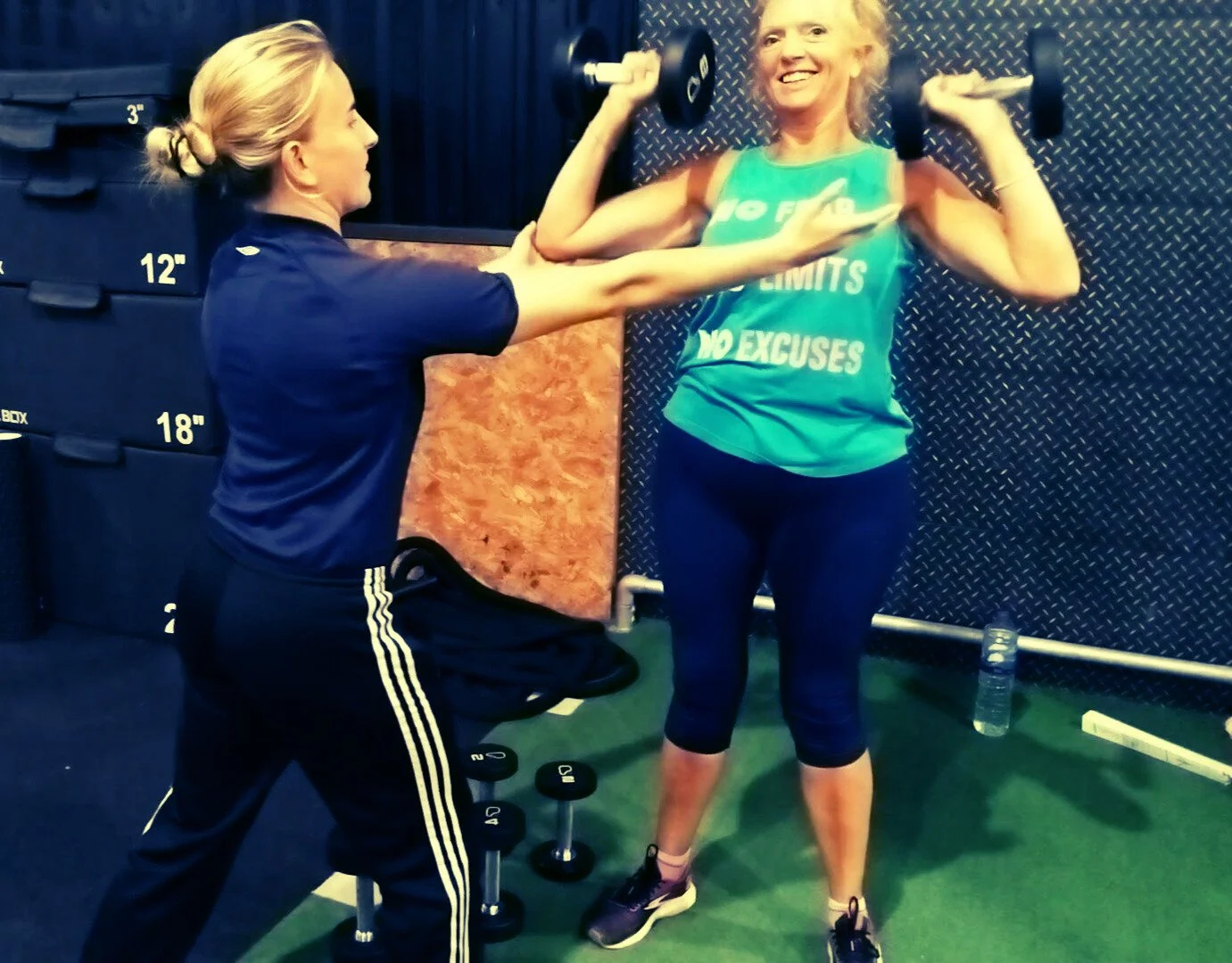 Scenic view of snow-capped mountains in the background, rolling green hills in the foreground, and a modern building on the hill.