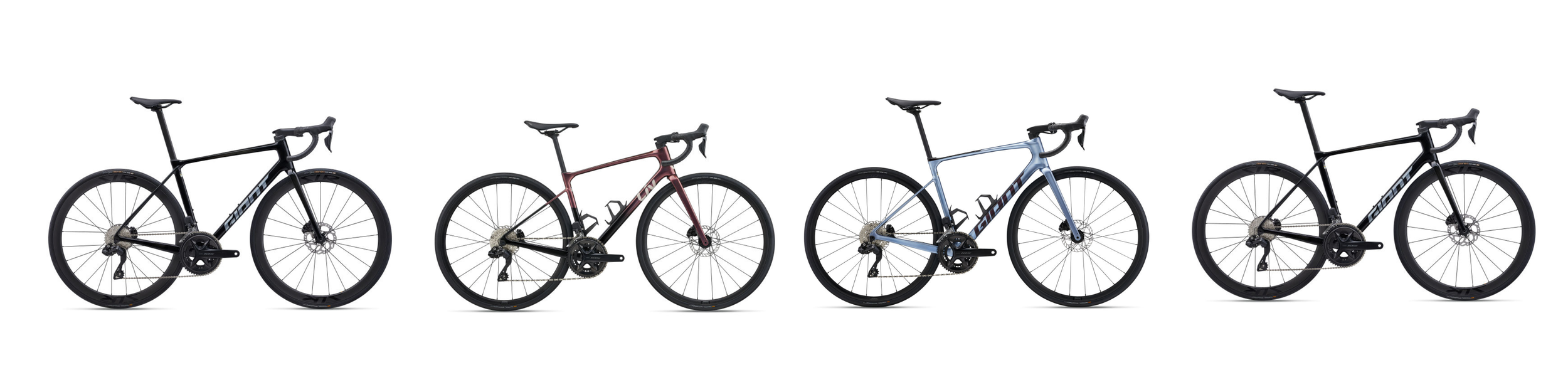 Row of four road bicycles with different colors against a white background.