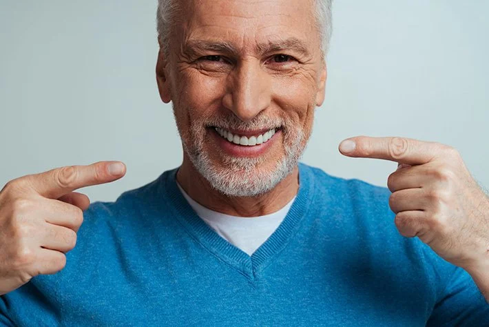 Smiling senior man pointing at himself with both hands