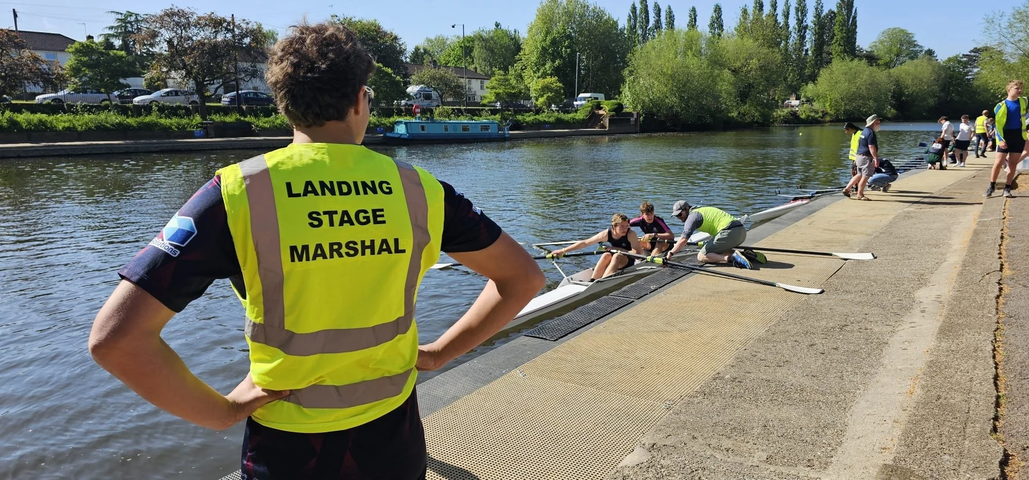 The landing stage at Evesham Rowing and Racquets Club watched over by one of the officials.