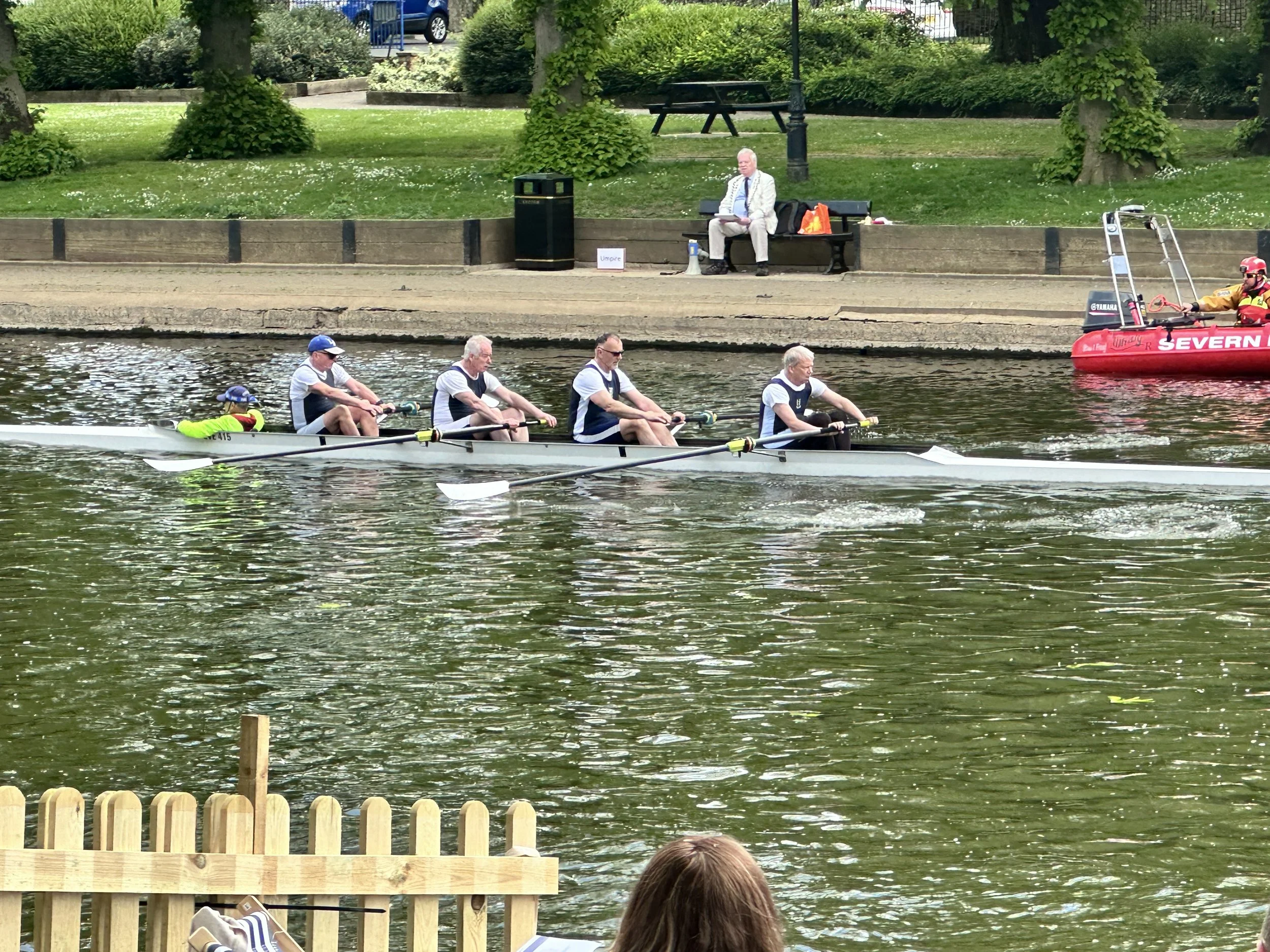 Here a coxed four goes past the Evesham Rowing Club finish line.