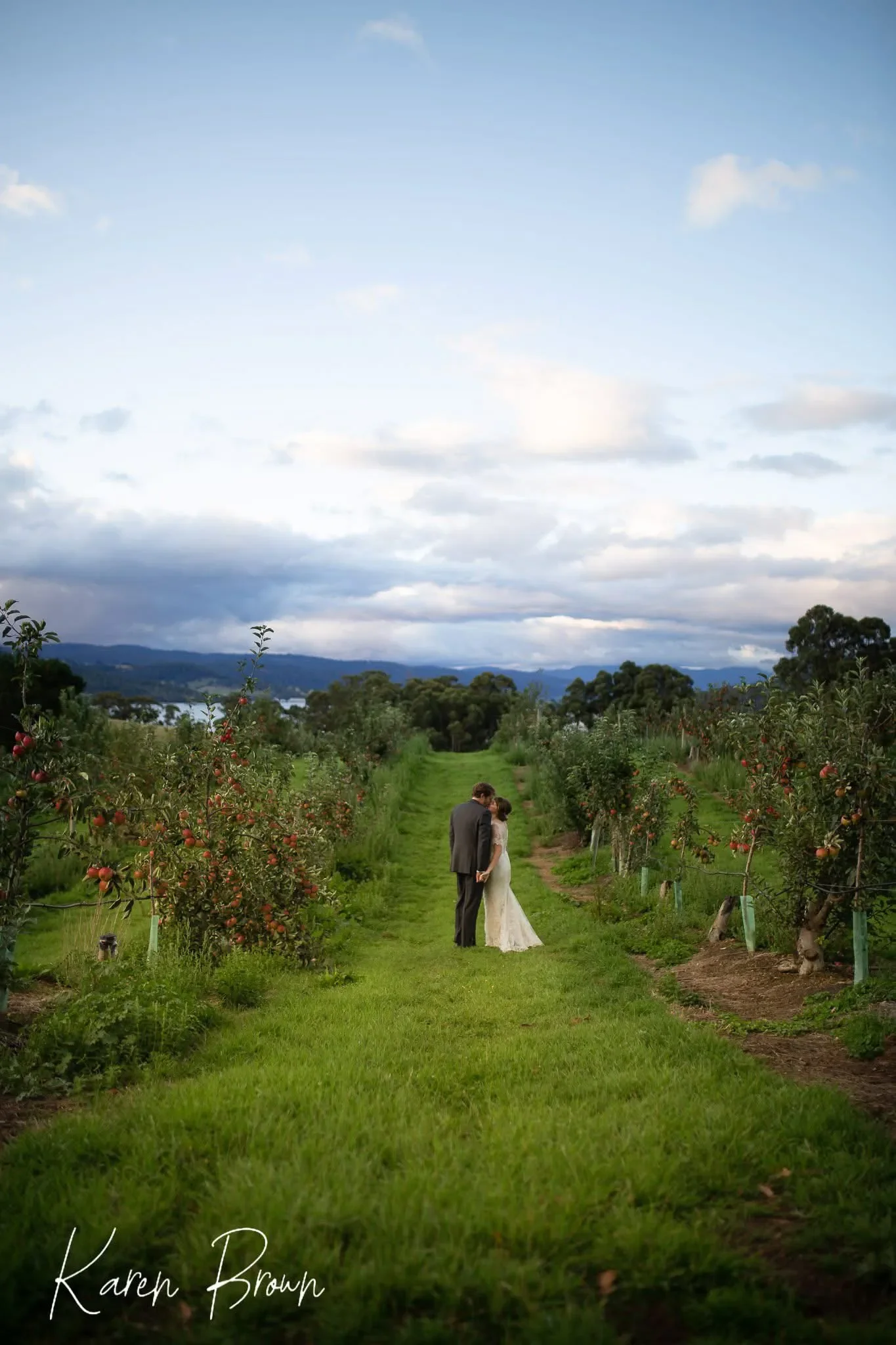 wedding photo of a couple in an apple orchid