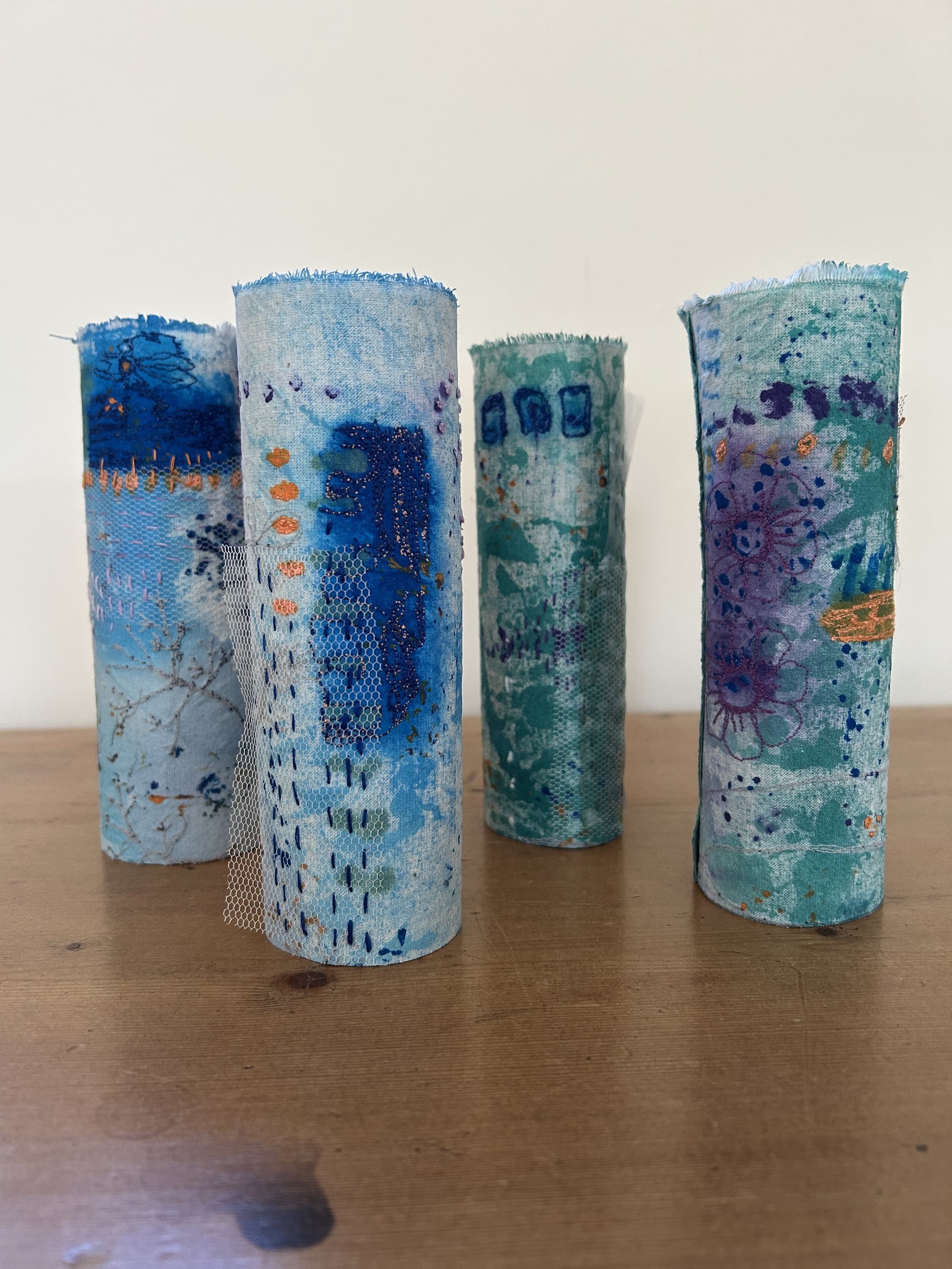 Hand printed and stitched cylinders
