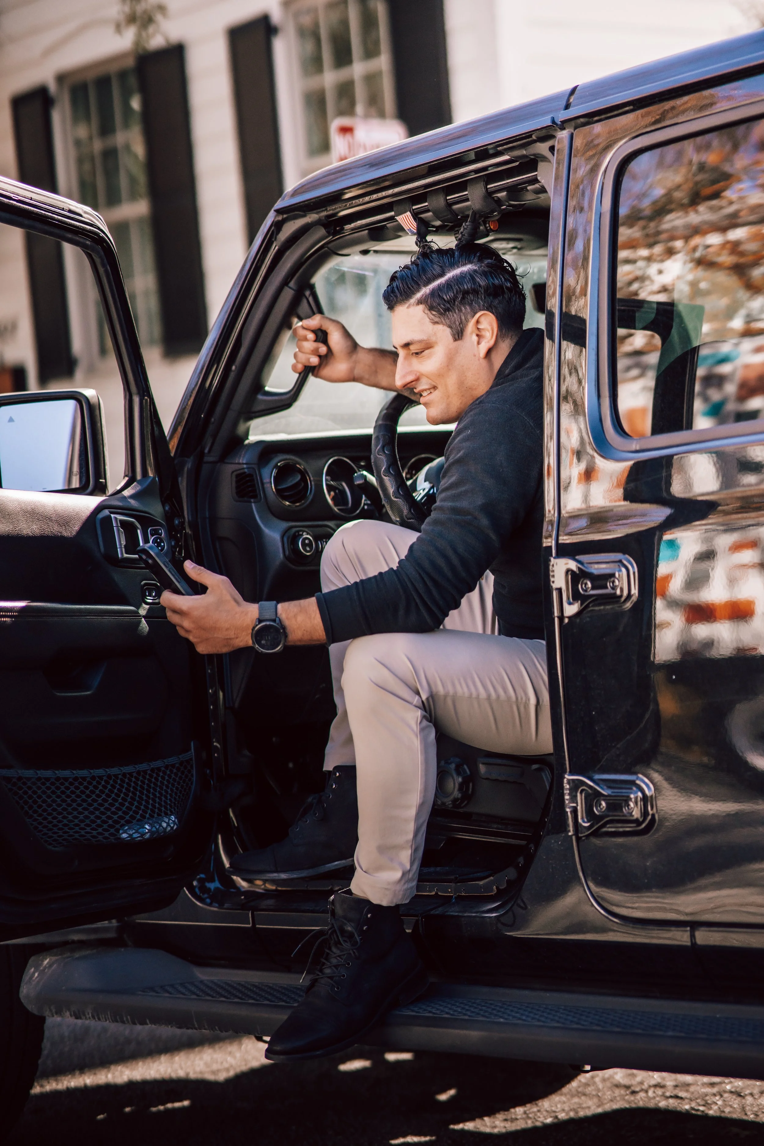 Alex Rodino entering a vehicle during an outdoor lifestyle portrait reflecting leadership and forward movement
