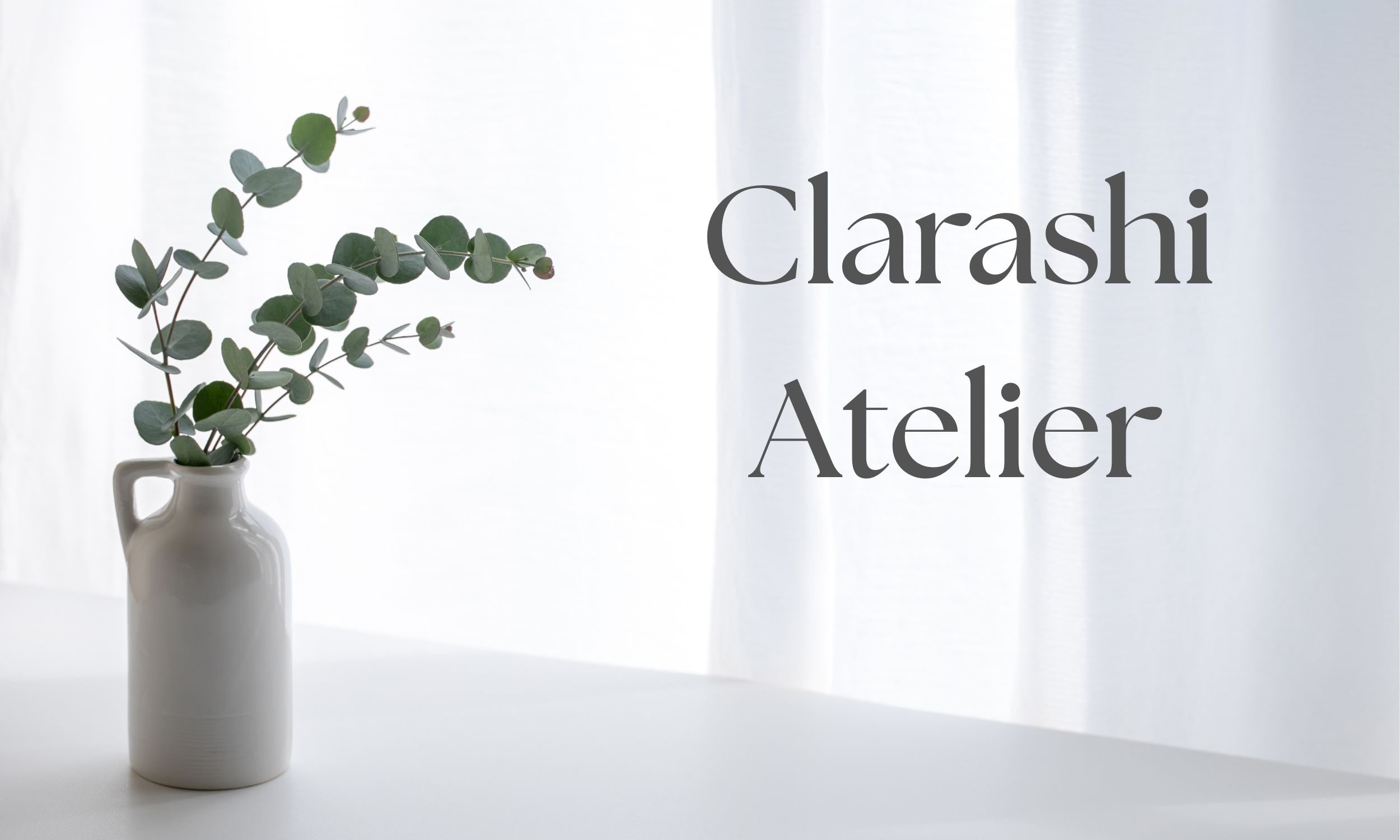 A white vase with green eucalyptus leaves on a white surface symbolising Clarashi Atelier: An integrated, six-month framework for high-acheiving professionals seeking therapeutic depth and strategic coaching clarity.