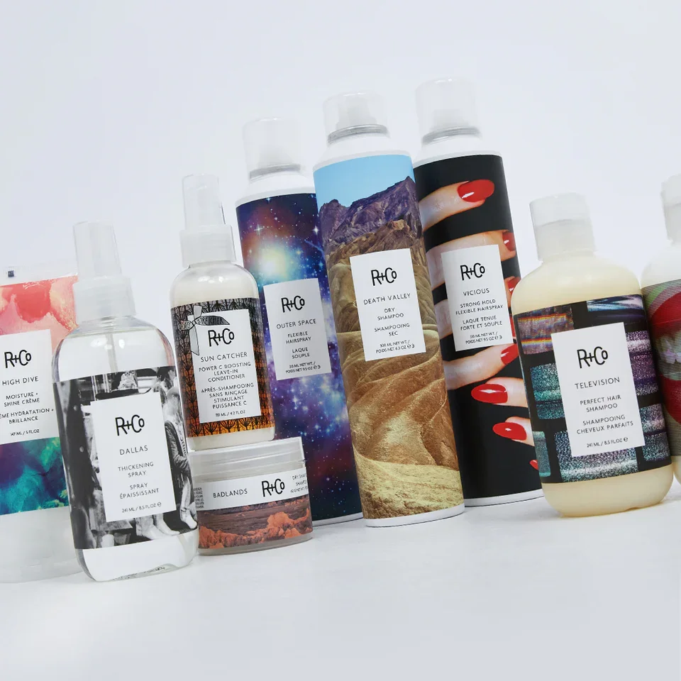 A collection of Rhodia branded hair care products including shampoo, conditioner, spray, and treatments with colorful, nature-inspired labels.