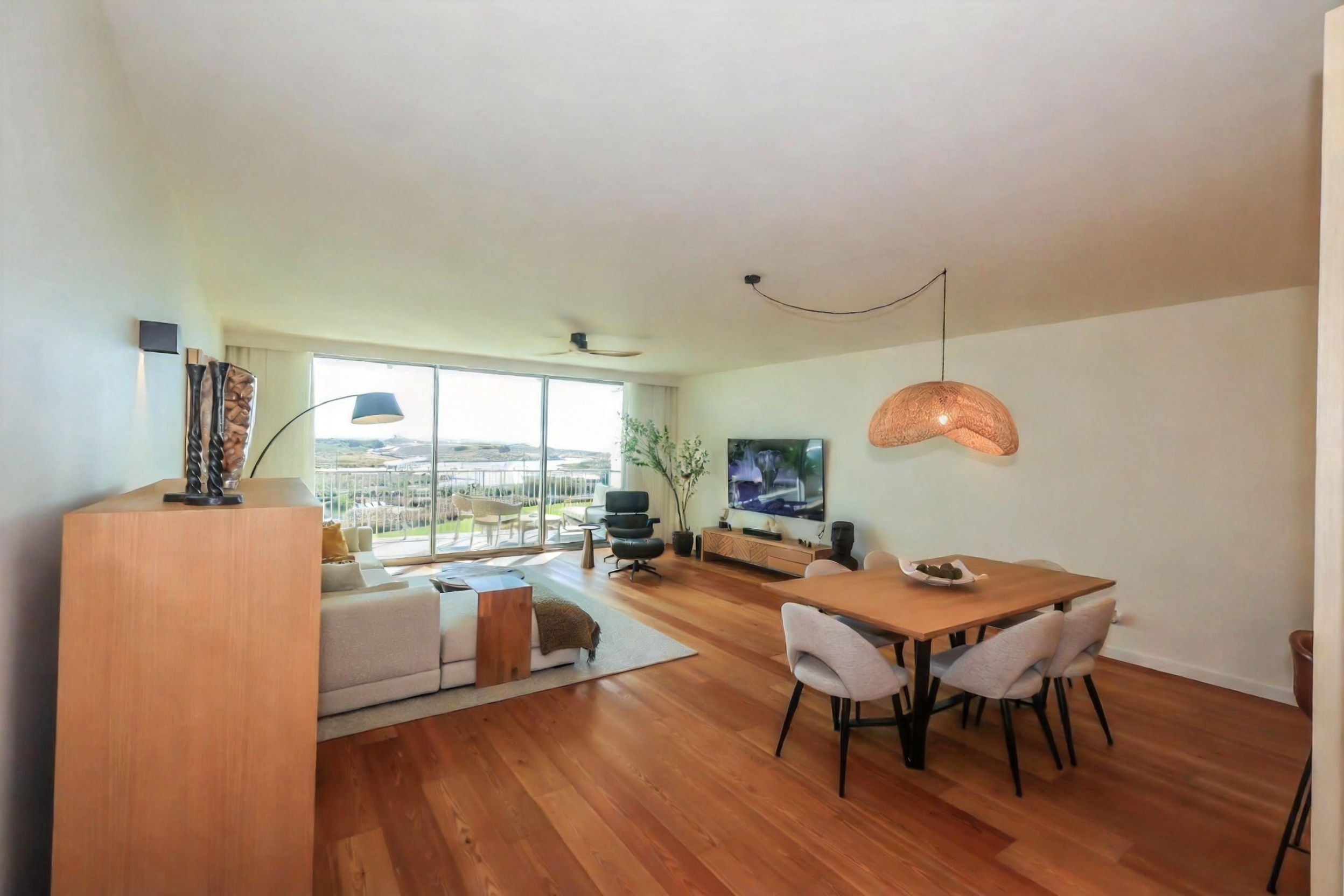 Inside — generous living space with hardwood floors throughout.