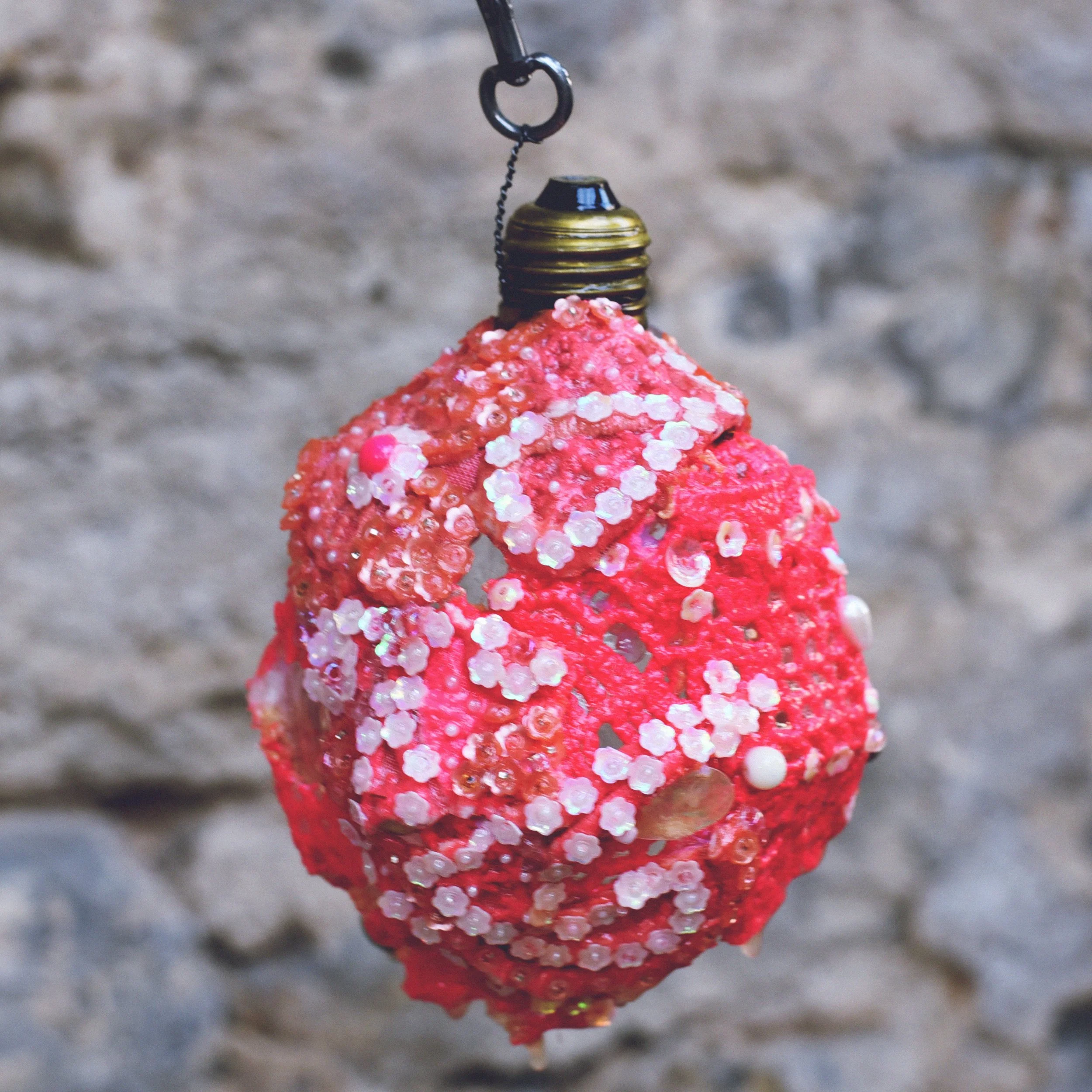 Hand embroidered paillettes and assorted beads on doilies. 