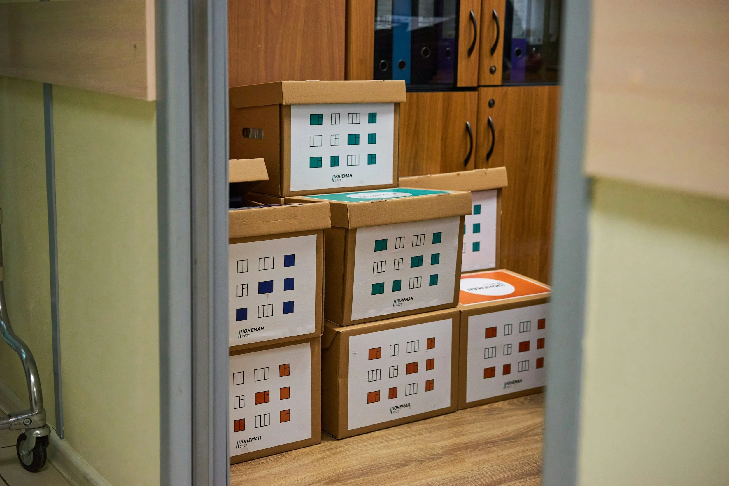 Organised colour coded moving boxes — downsizing after 60 on The Rebel Age