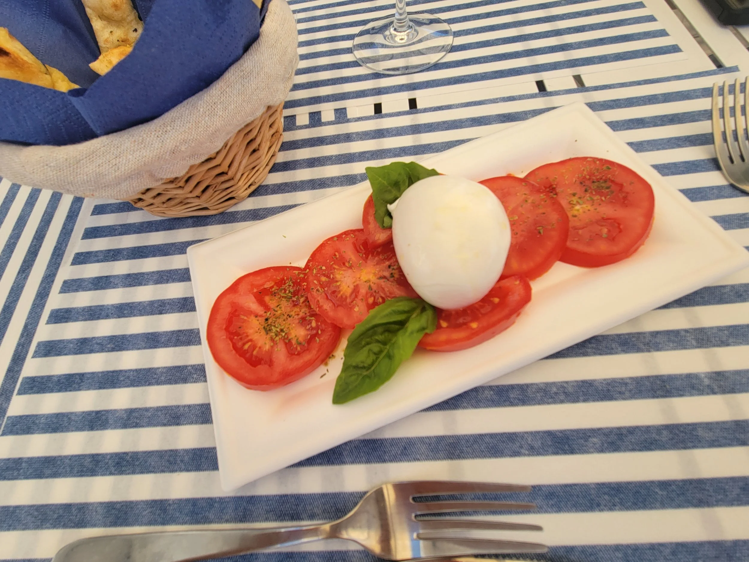 Caprese Salad with fresh tomatoes enjoyed seaside in Amalfi