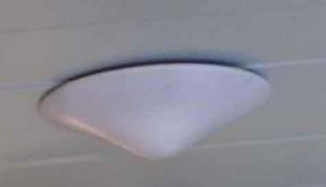 Close-up of a ceiling-mounted, rounded white light fixture.
