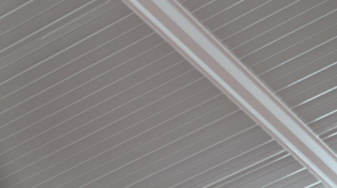 Close-up of a metallic structure with parallel lines and beams