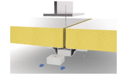 Cross-section of a construction or insulation installation showing layers of building materials, including yellow insulation and structural components, with some blue object below.