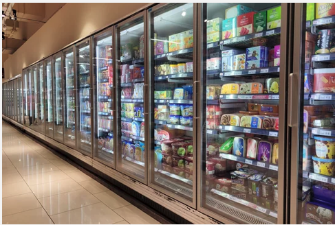 Frozen food aisle in a grocery store with glass doors.