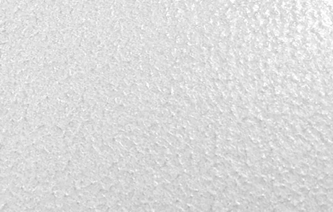 Close-up of a white textured wall surface.