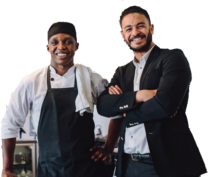 A chef and a man in a black blazer smiling and standing with arms crossed.