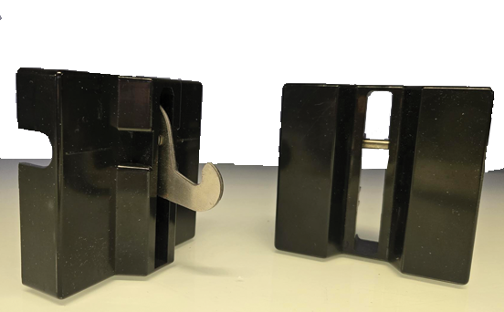 Black plastic objects with open slots, possibly parts of a mechanical or industrial device.