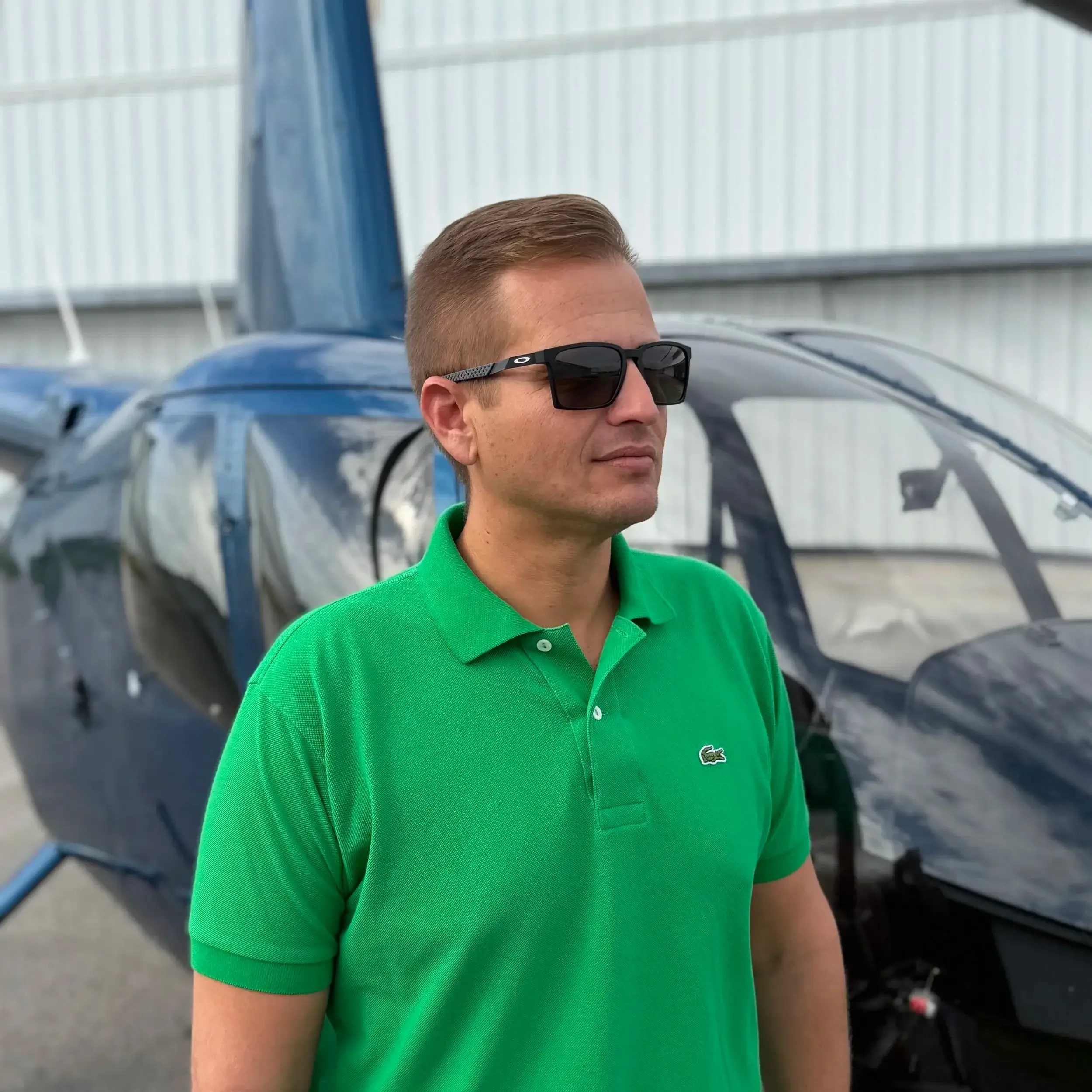 Helicopter pilot Justin standing in from of helicopter