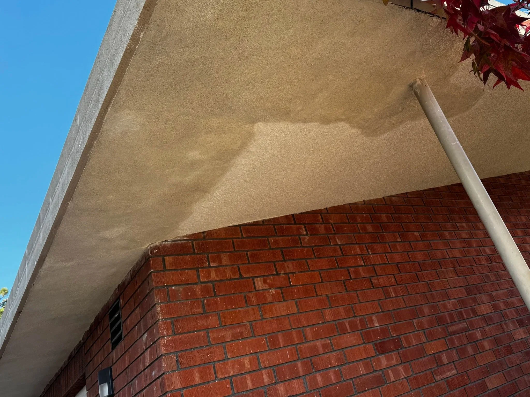 Continuous soffit installation with stucco finish by Foremost Building Solutions.