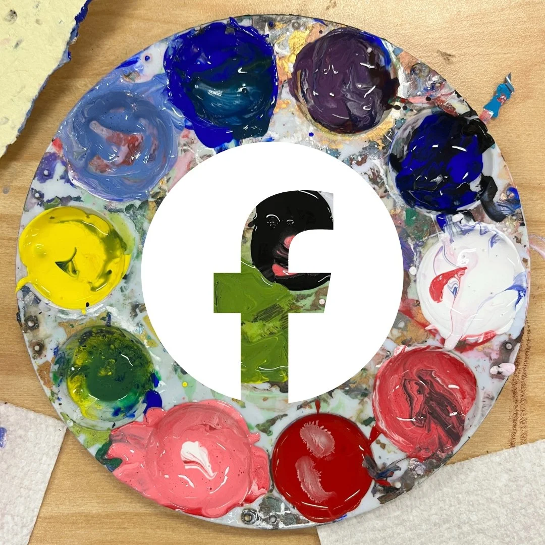 A paint palette with various colors of paint arranged in a circle. Overlaid in the center is a white circle with a black Facebook logo and a small black face with a tongue sticking out behind the logo.