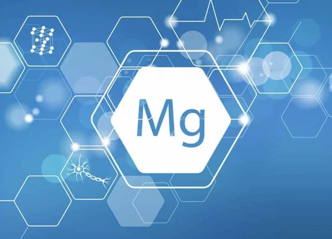 Illustration of a medical or scientific theme with hexagonal shapes, molecular structures, and a central hexagon displaying the chemical symbol Mg for magnesium.