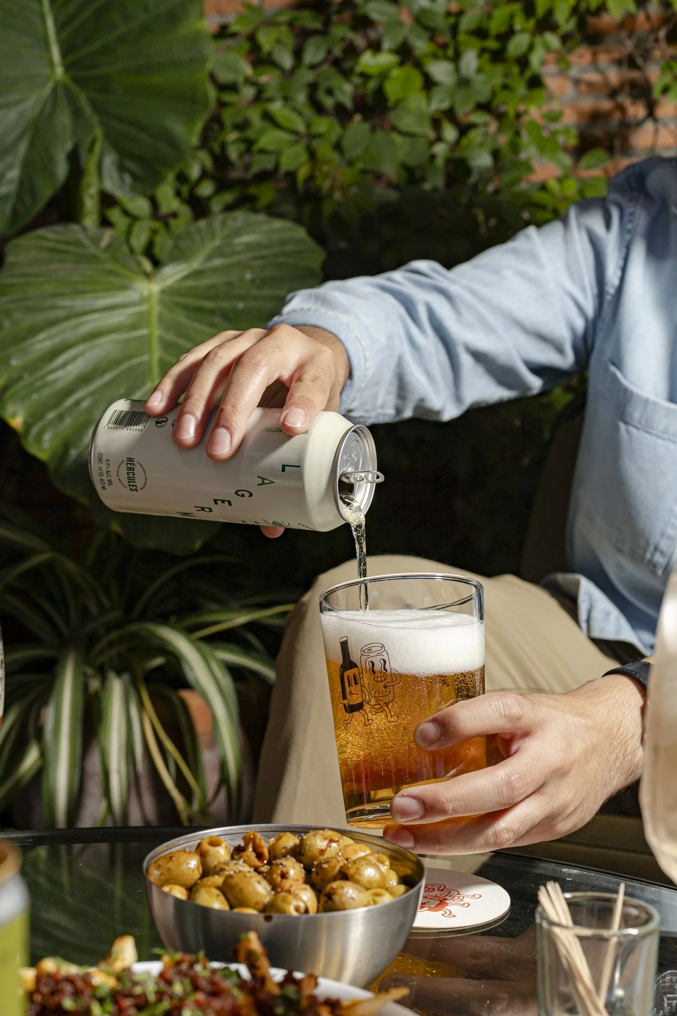 Una persona vierte cerveza desde una lata en un vaso.