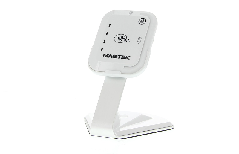 White contactless payment device with MagTek branding on a stand.