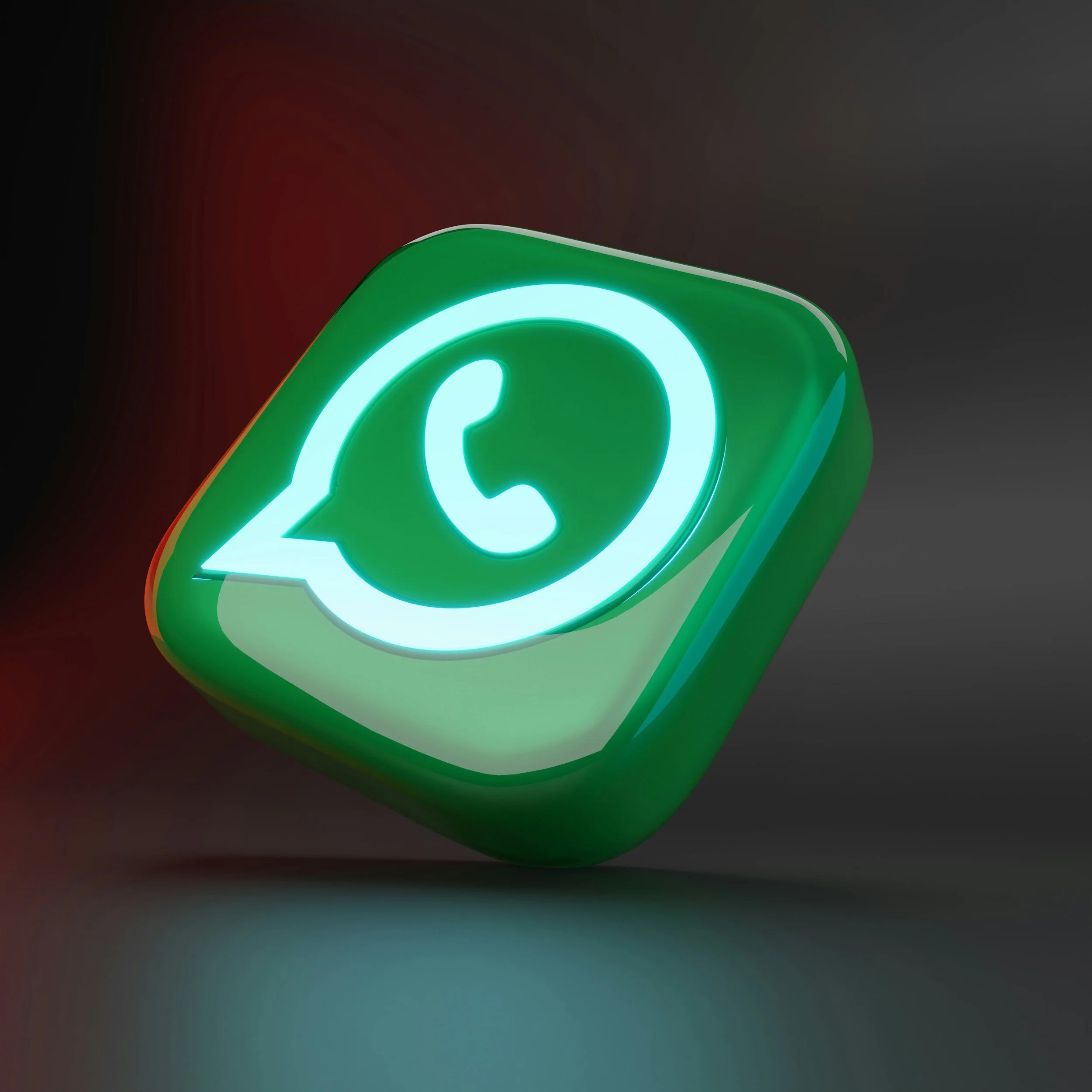 A 3D rendered icon of the WhatsApp logo glowing in green and white, with a chat bubble and a telephone symbol inside, set against a dark gradient background.