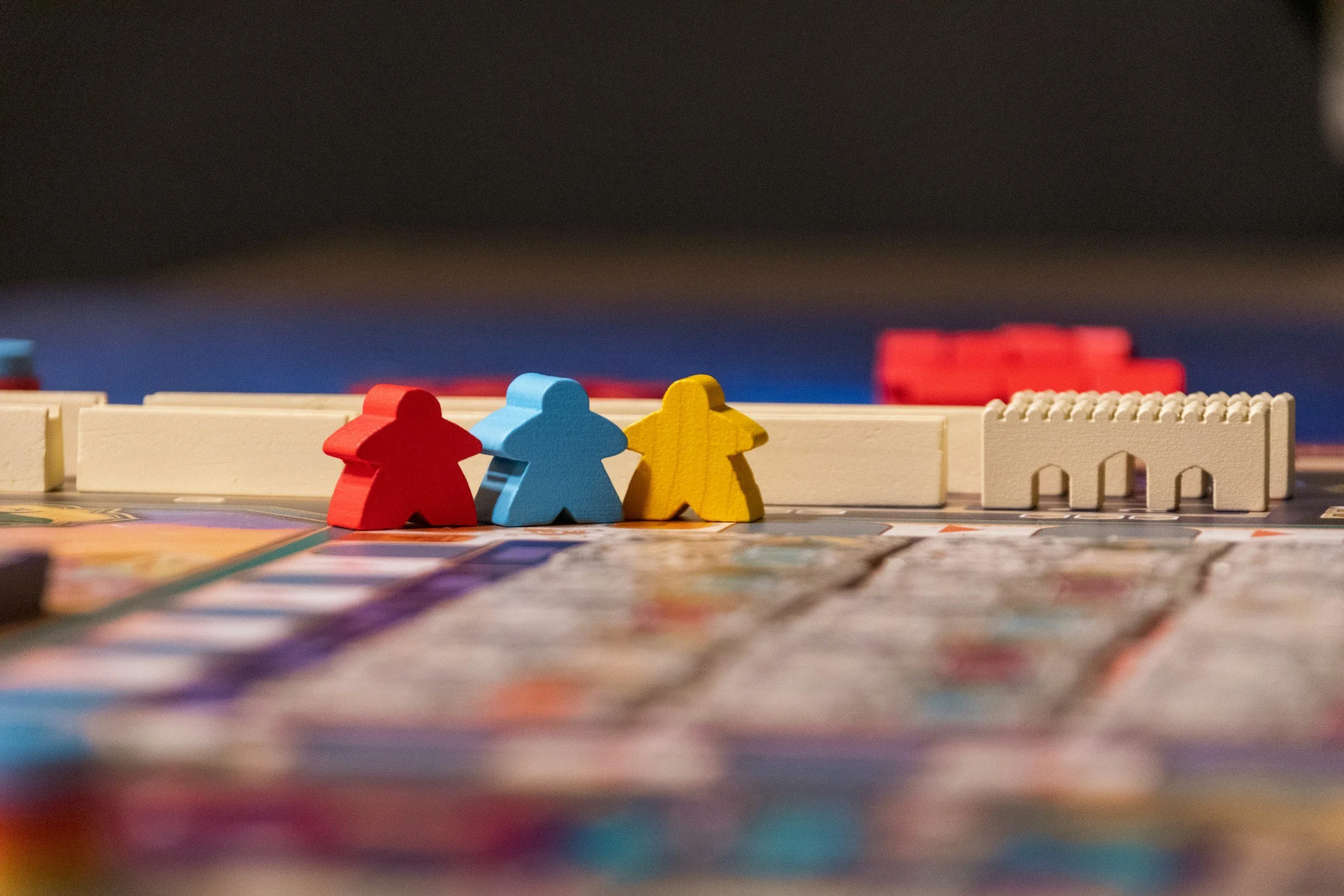 Colorful game pieces and tiles on a board game.