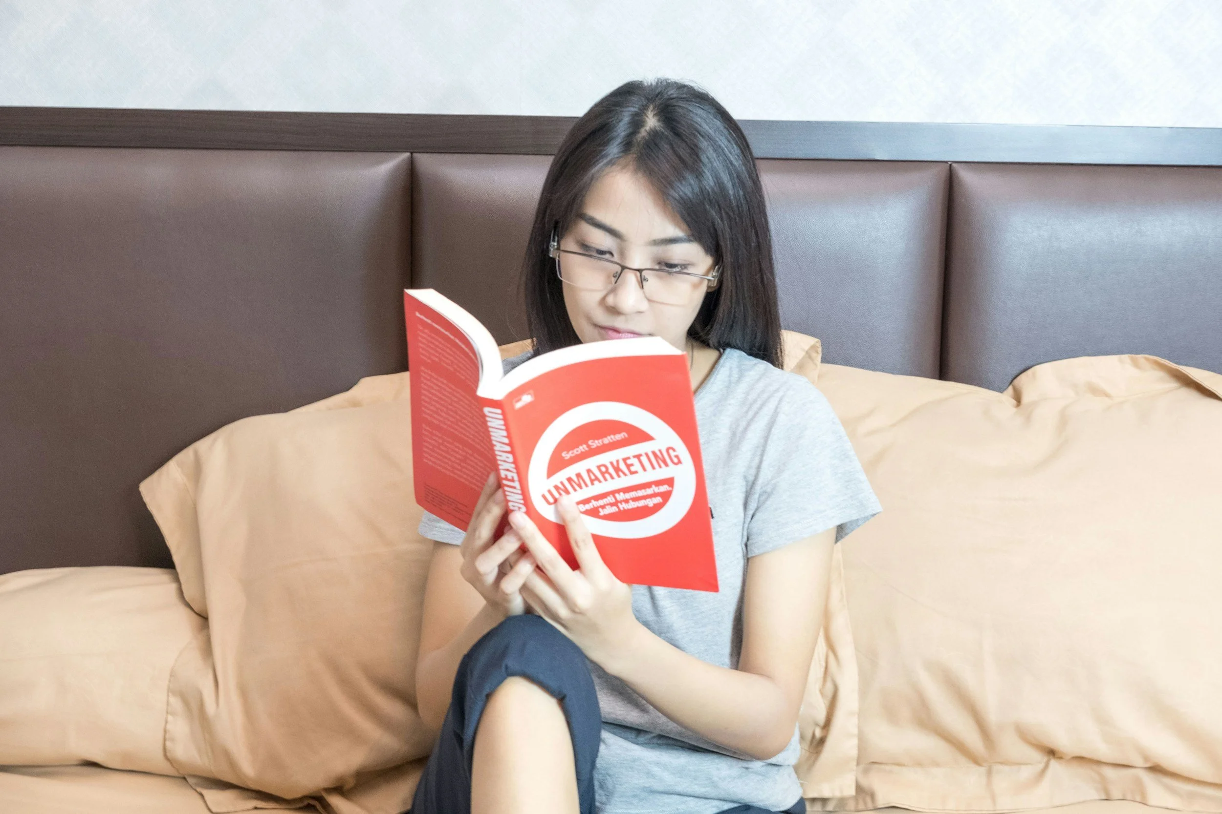 girl sitting on couch reading a book
