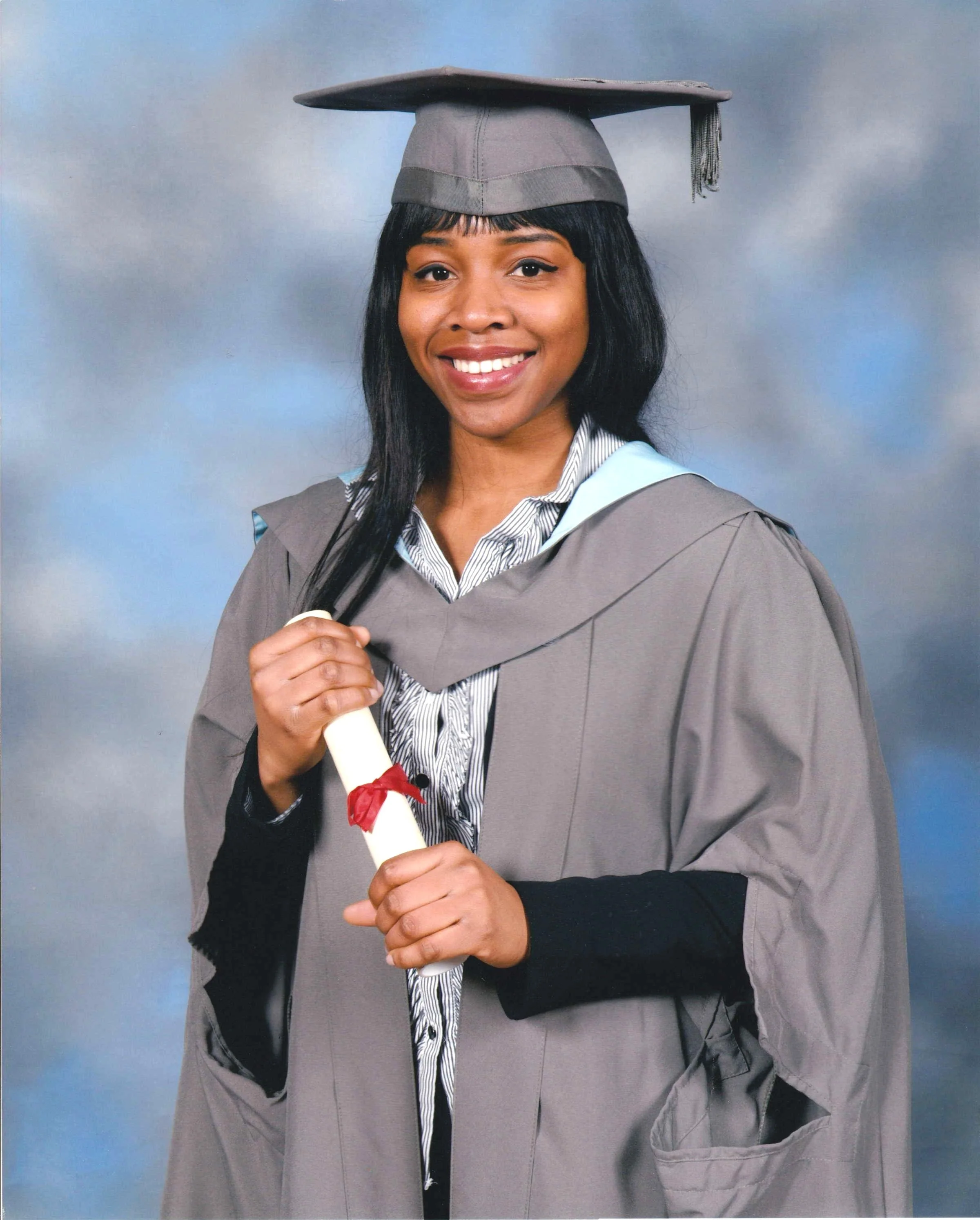 Ope the Tutor wearing University of York (Russell Group) graduation robes, holding a Chemistry Masters diploma