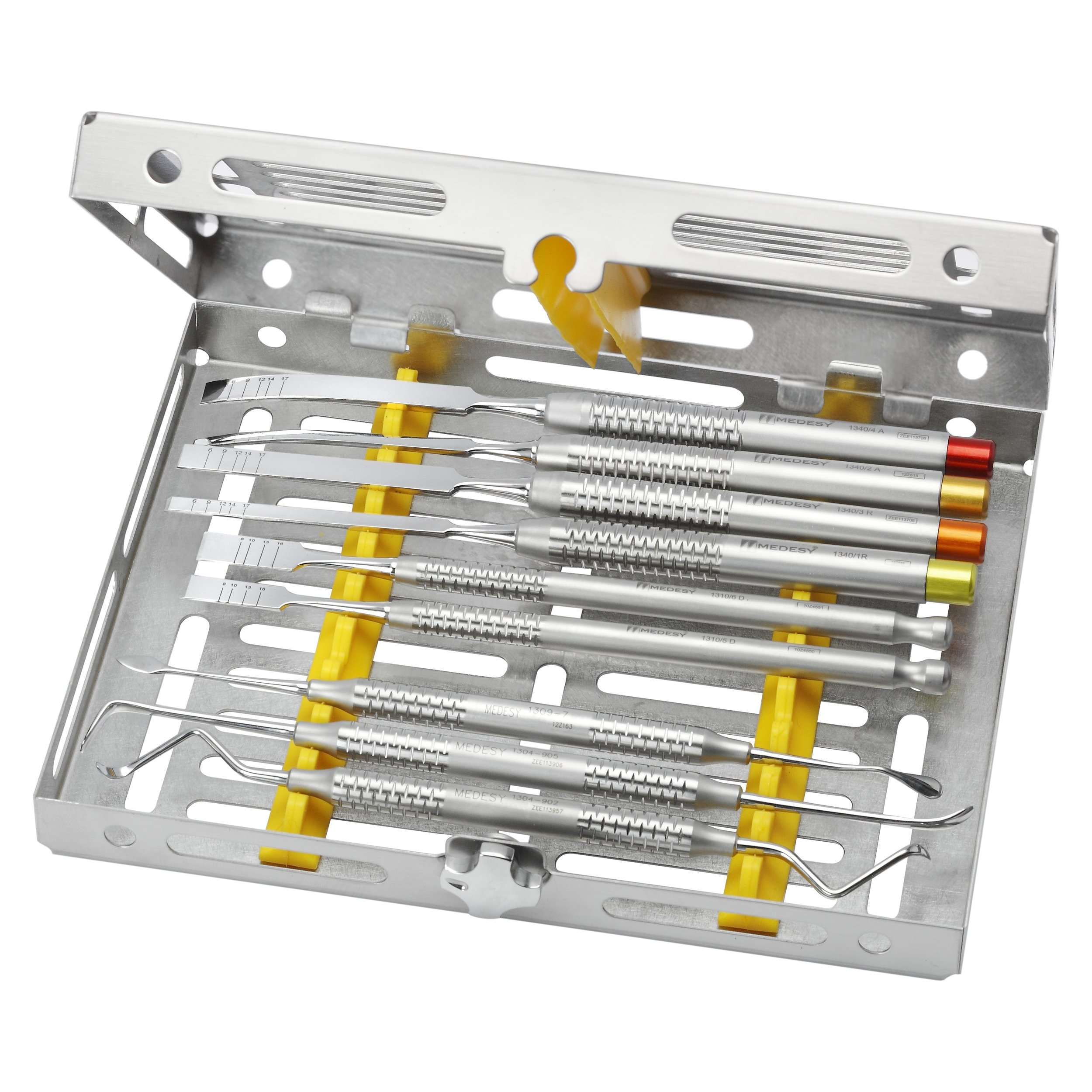 Dental scaler and probe set in a metal tray with yellow holders.