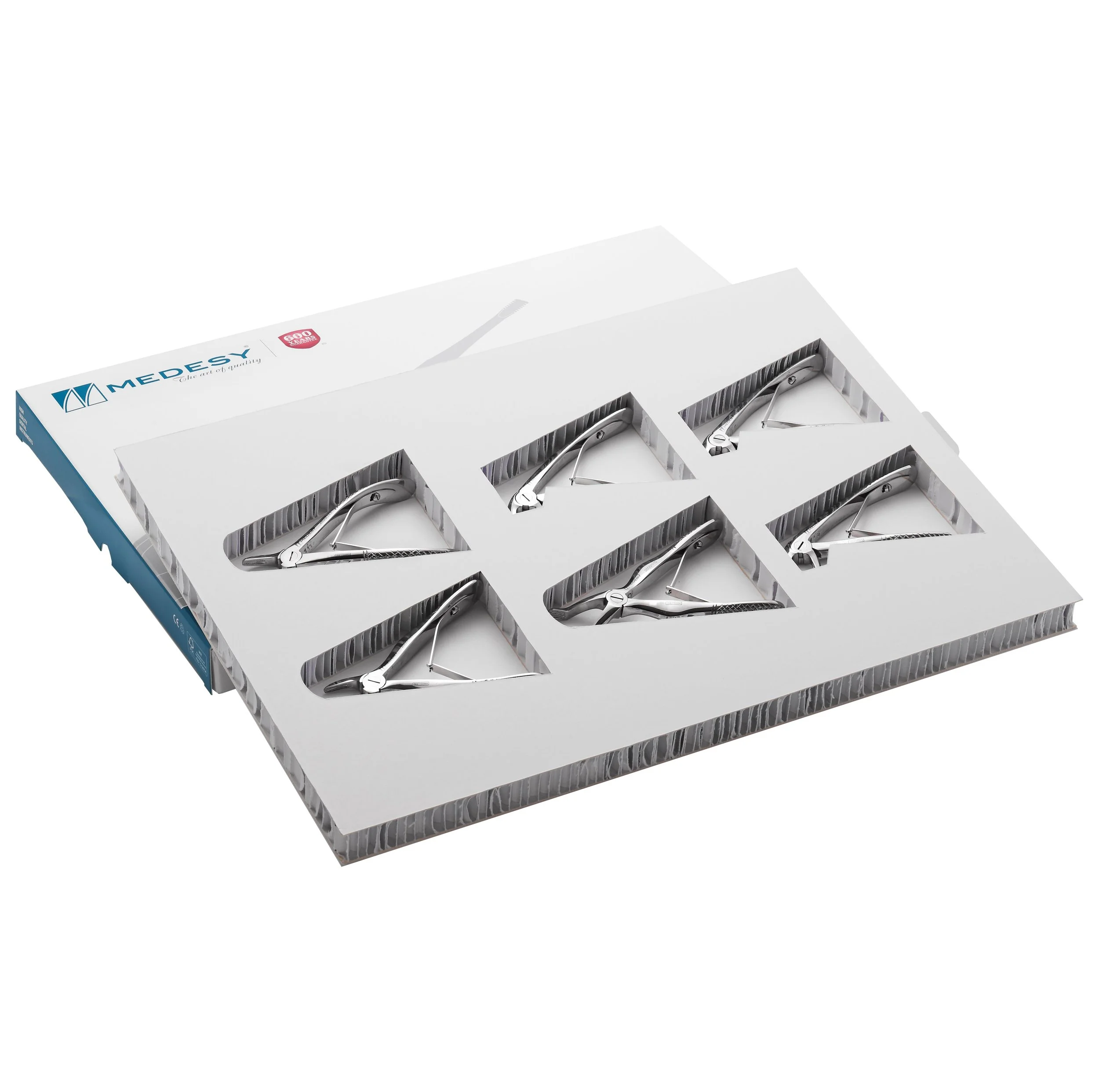 Set of five sanitary surgical instruments in foam packaging for medical use.