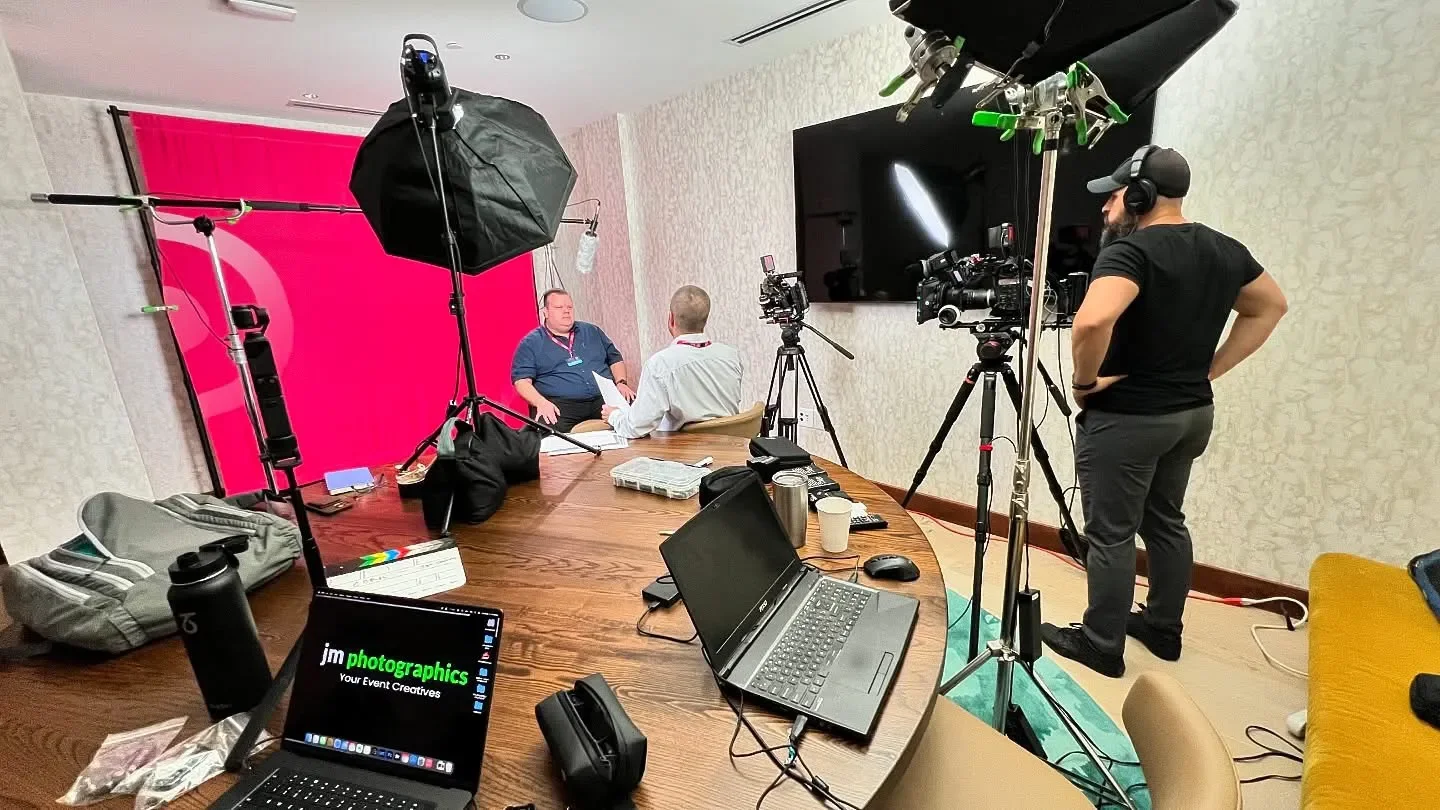 Behind-the-scenes view of a professional event videography interview setup in Atlanta by jm photographics, featuring high-quality lighting and audio equipment for corporate and nonprofit testimonials.