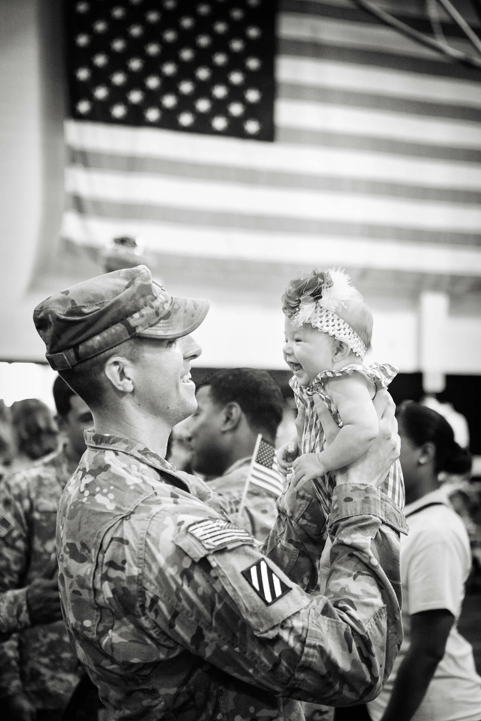 Emotional military homecoming photography in Georgia, capturing a soldier reuniting with family, provided as a service to active-duty members.