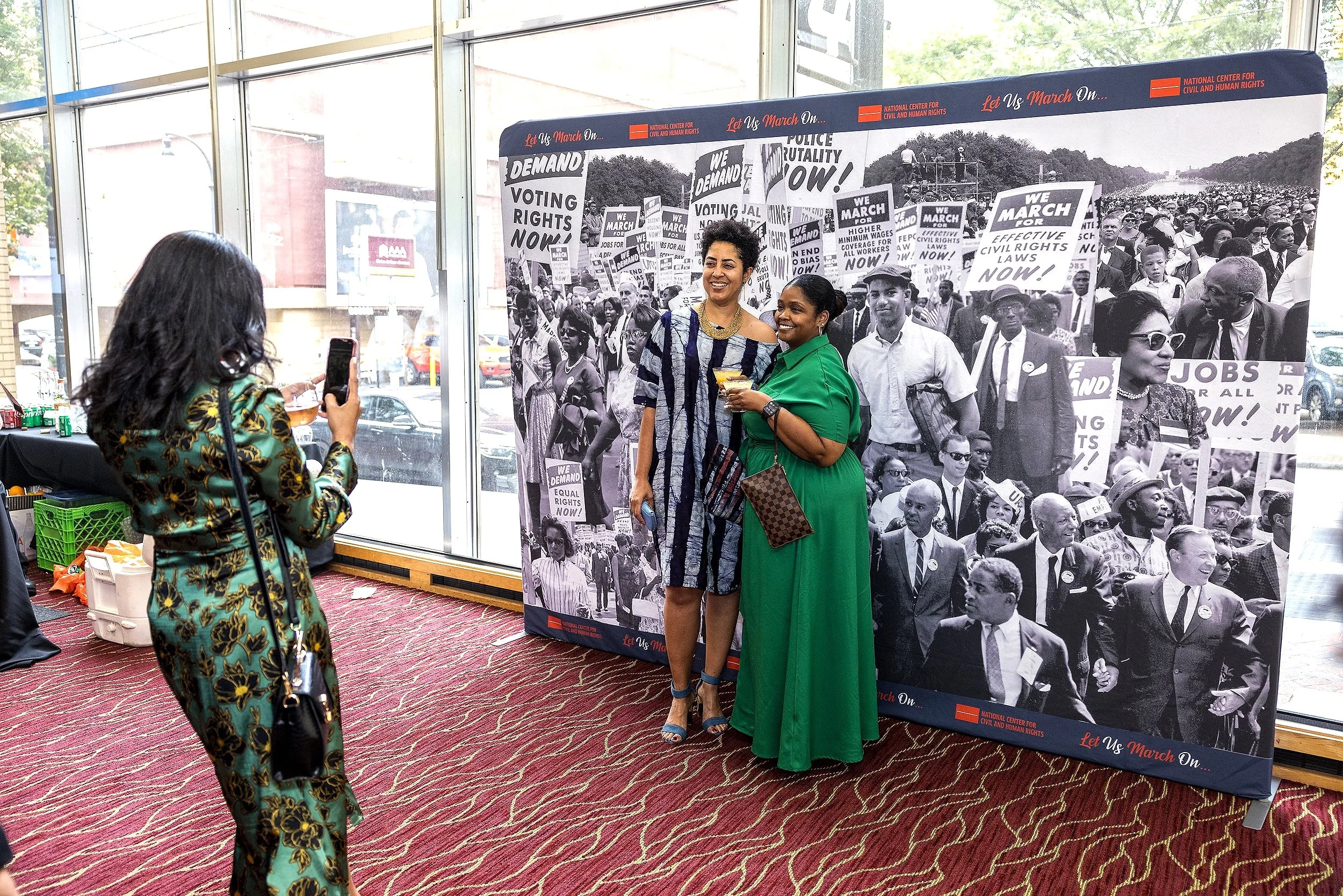 Roaming event photographer capturing candid moments at a charity event for National Center for Civil and Human Rights at the Rialto Center for the Arts in downtown Atlanta.