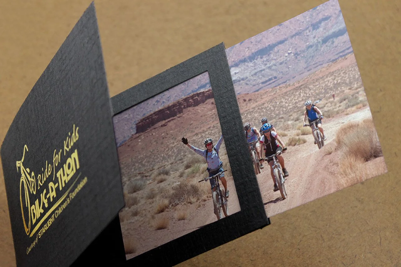 High-quality 4x6 event photo print being placed into a custom branded folder for instant guest delivery at a gala.