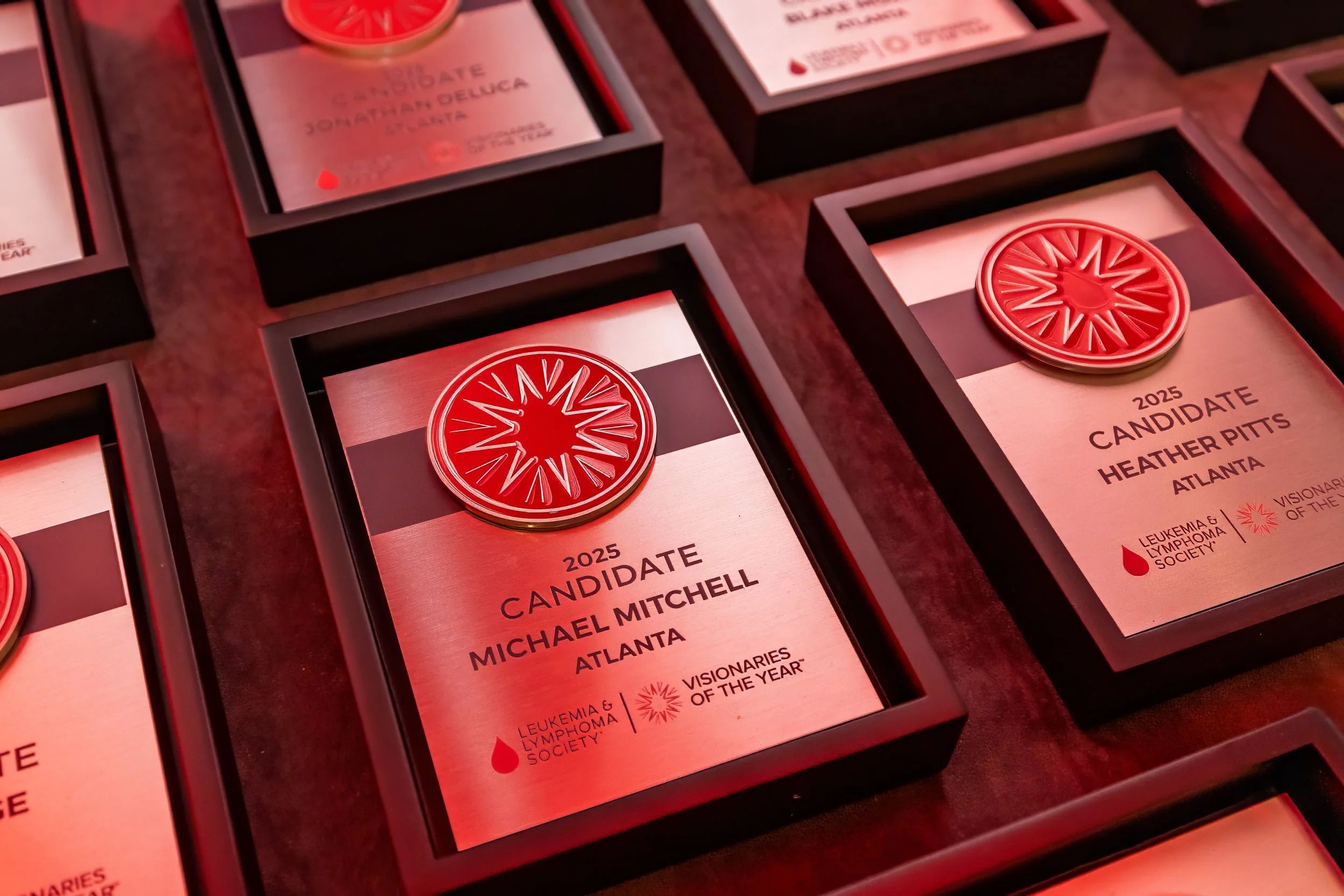 Awards plaque with a red and white medal on top, inscribed with '2025 Candidate Heather Pitts Atlanta' and logos of Leukemia & Lymphoma Society and Visionaries of the Year.