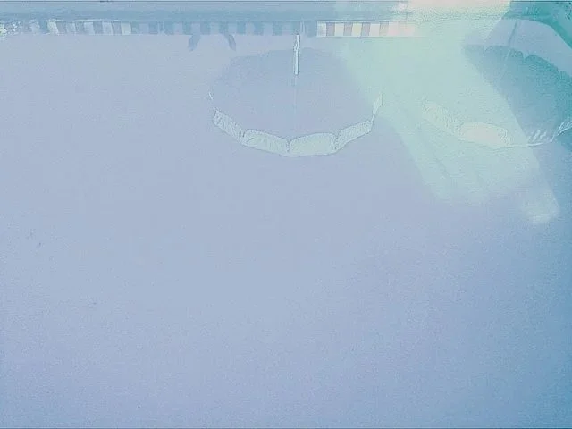 A clear swimming pool with a plastic chain placed around the edge.