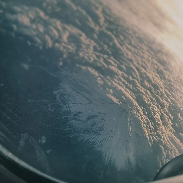 View of Earth from space showing cloud formations and icebergs at the pole.