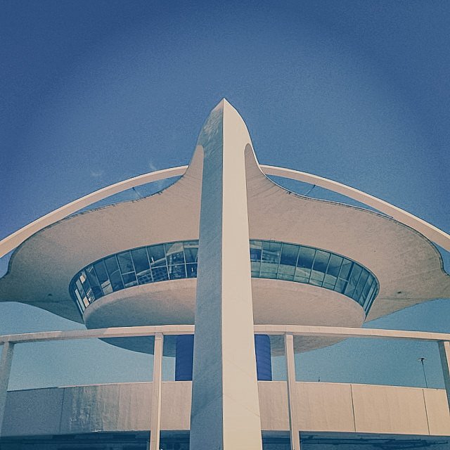 The Space Needle, a tall, futuristic observation tower in Seattle, Washington, viewed from below against a clear blue sky.