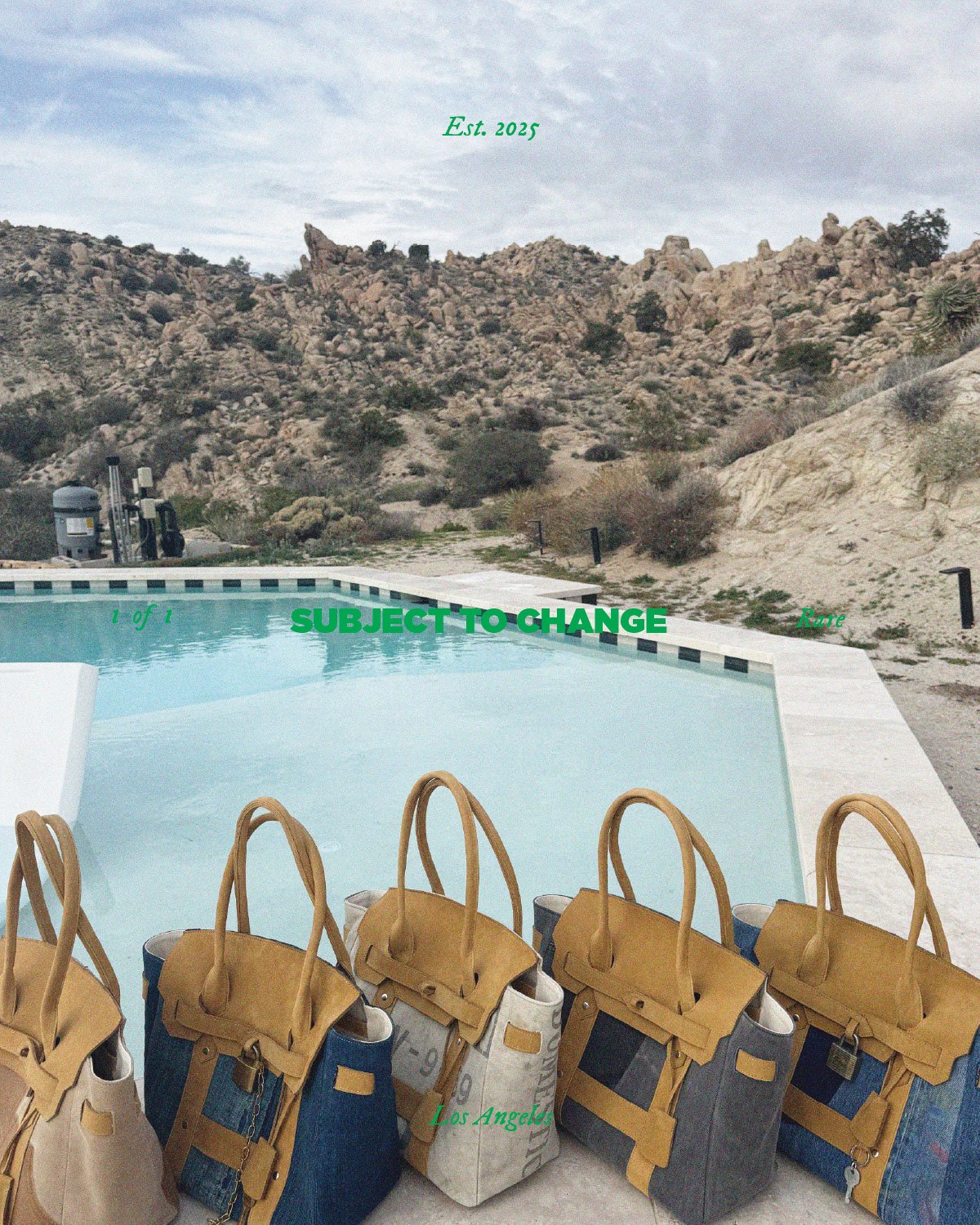 A collection of beige, blue, and gray handbags with leather straps are lined up in front of a swimming pool in a desert landscape with rocky hills and sparse vegetation. Text on the image reads 'Est. 2025', '1 of 1', 'SUBJECT TO CHANGE' in green, 'Ra