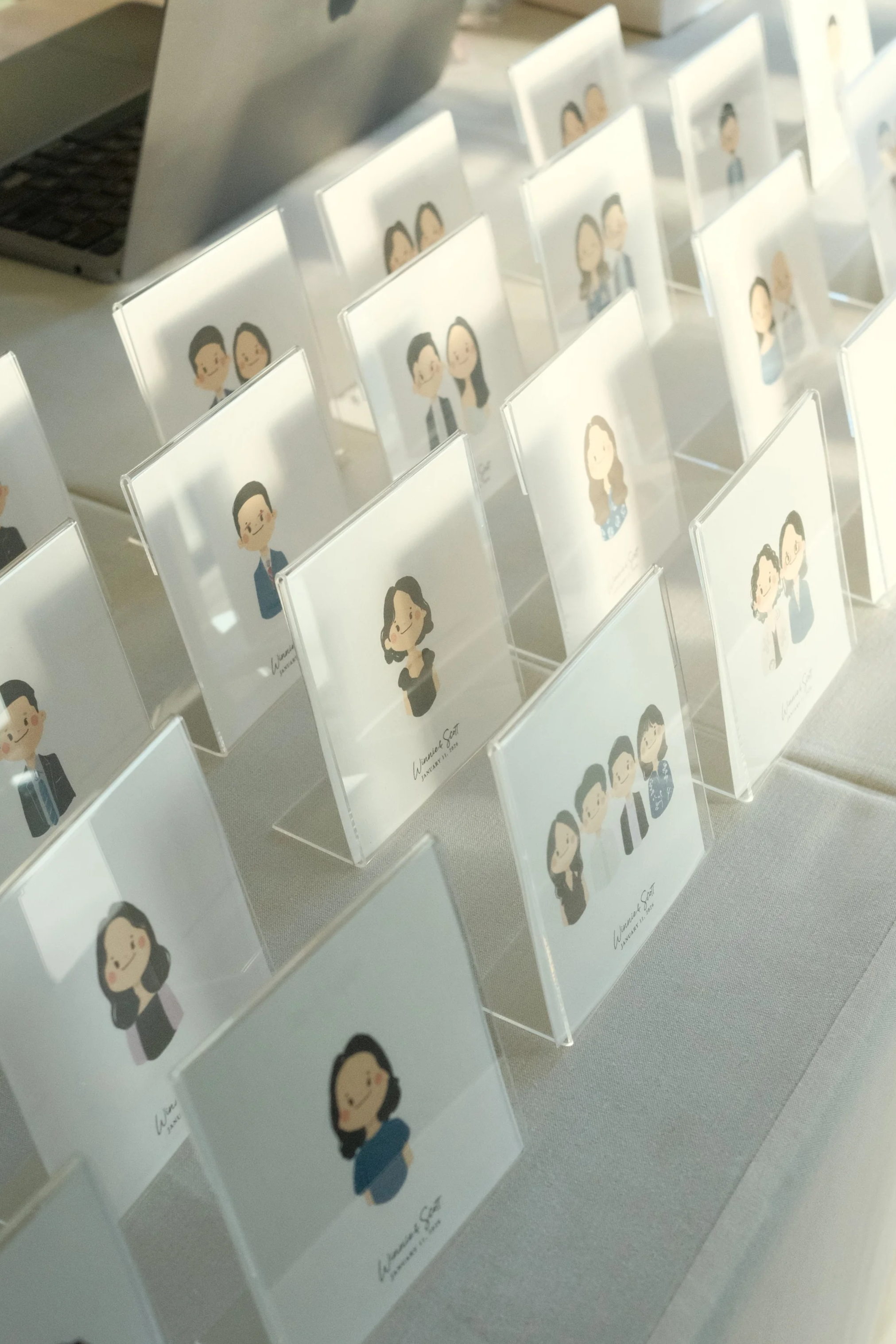 Collection of illustrated portrait cards featuring diverse characters displayed upright on a table.