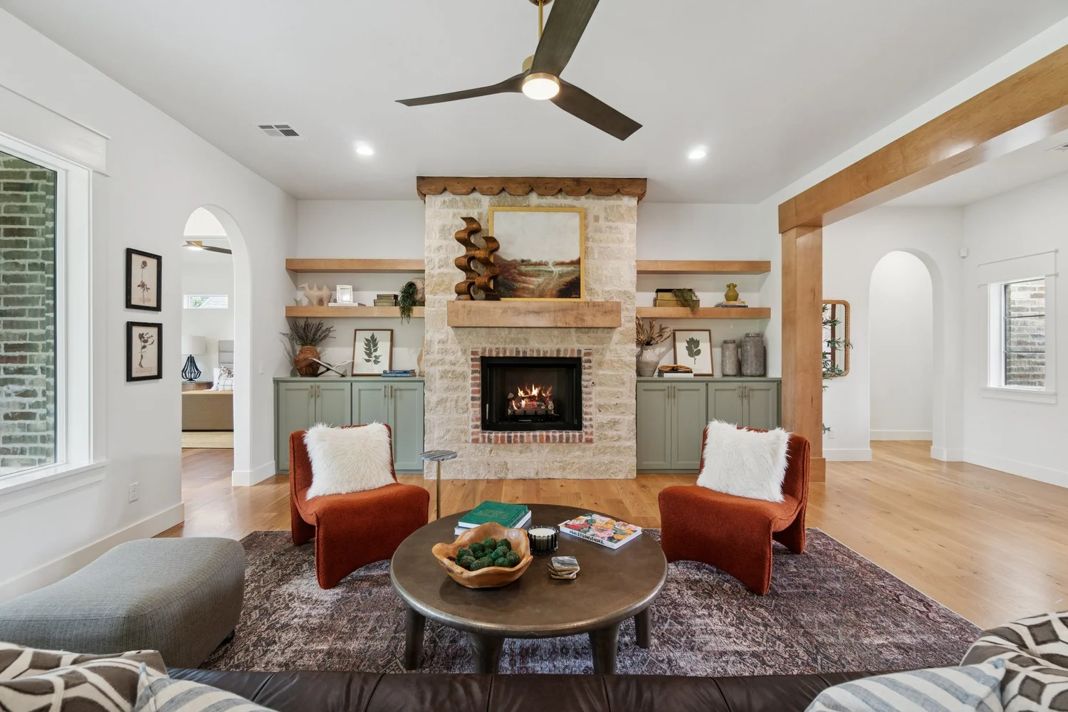 Living room with a stone fireplace, photographed by Nested Tours